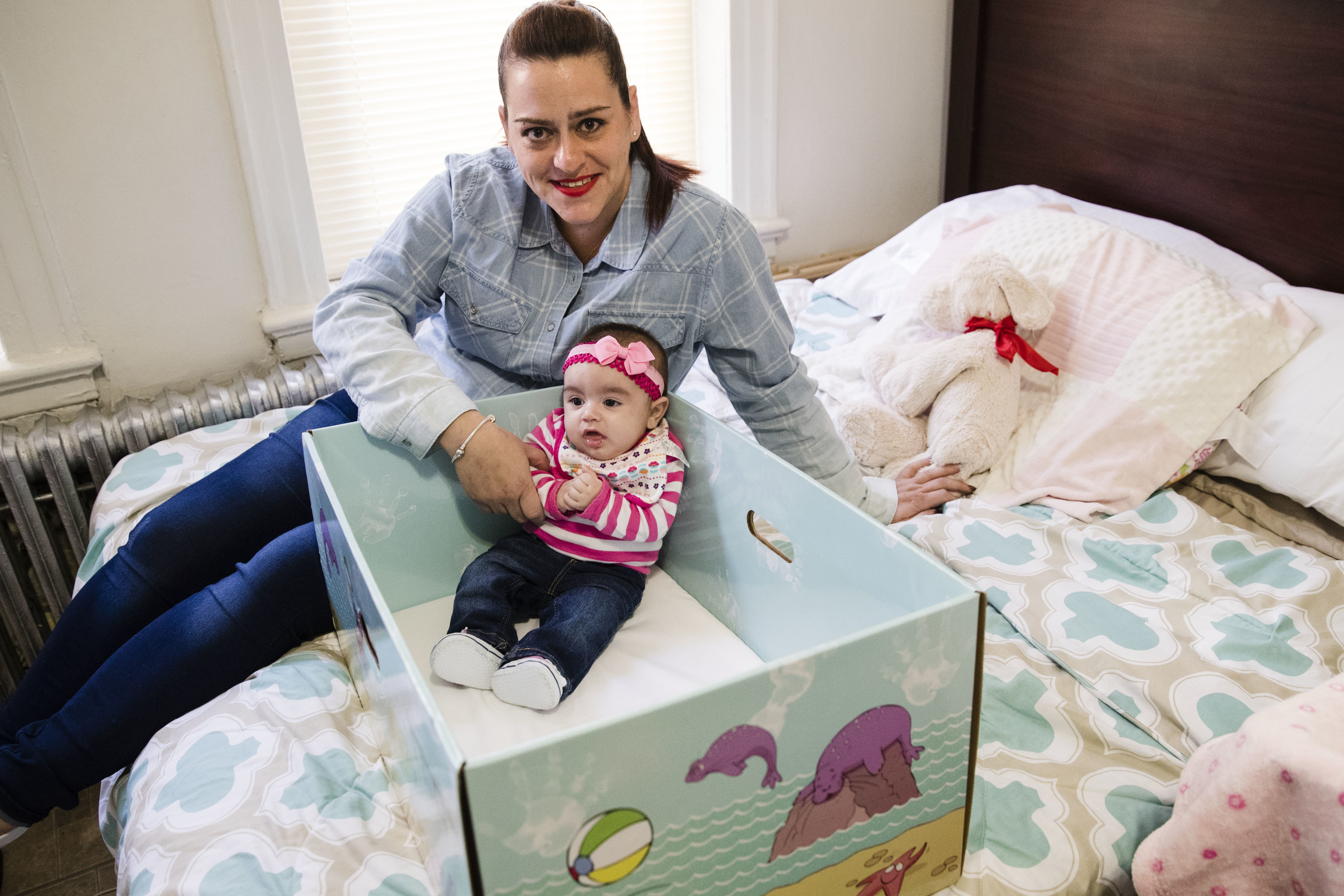 Dolores Peterson and her three-month-old daughter Ariabella pose for a photograph at their home in Camden, N.J., Monday, March 6, 2017. New Jersey became the first state to send newborn babies and their parents home with a box that doubles as a crib and full of necessities, with the aim of cutting back on sudden infant death syndrome. (AP Photo/Matt Rourke)