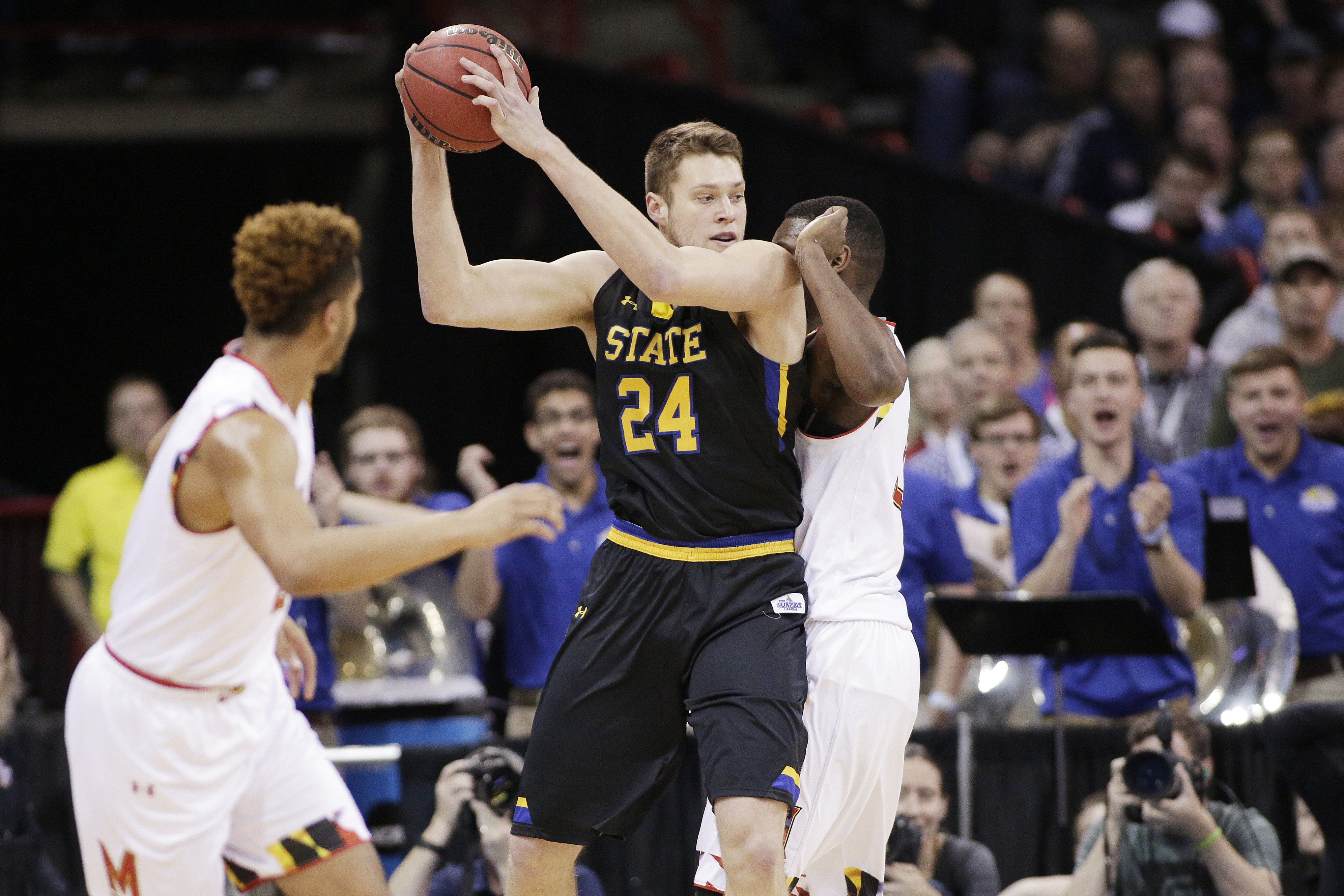 South Dakota State forward Mike Daum (24) holds the ball while defended by Maryland center Diamond Stone during the first half of a first-round men's college basketball game in the NCAA Tournament in Spokane, Wash., Friday, March 18, 2016. (Young Kwak, AP Photo, File)