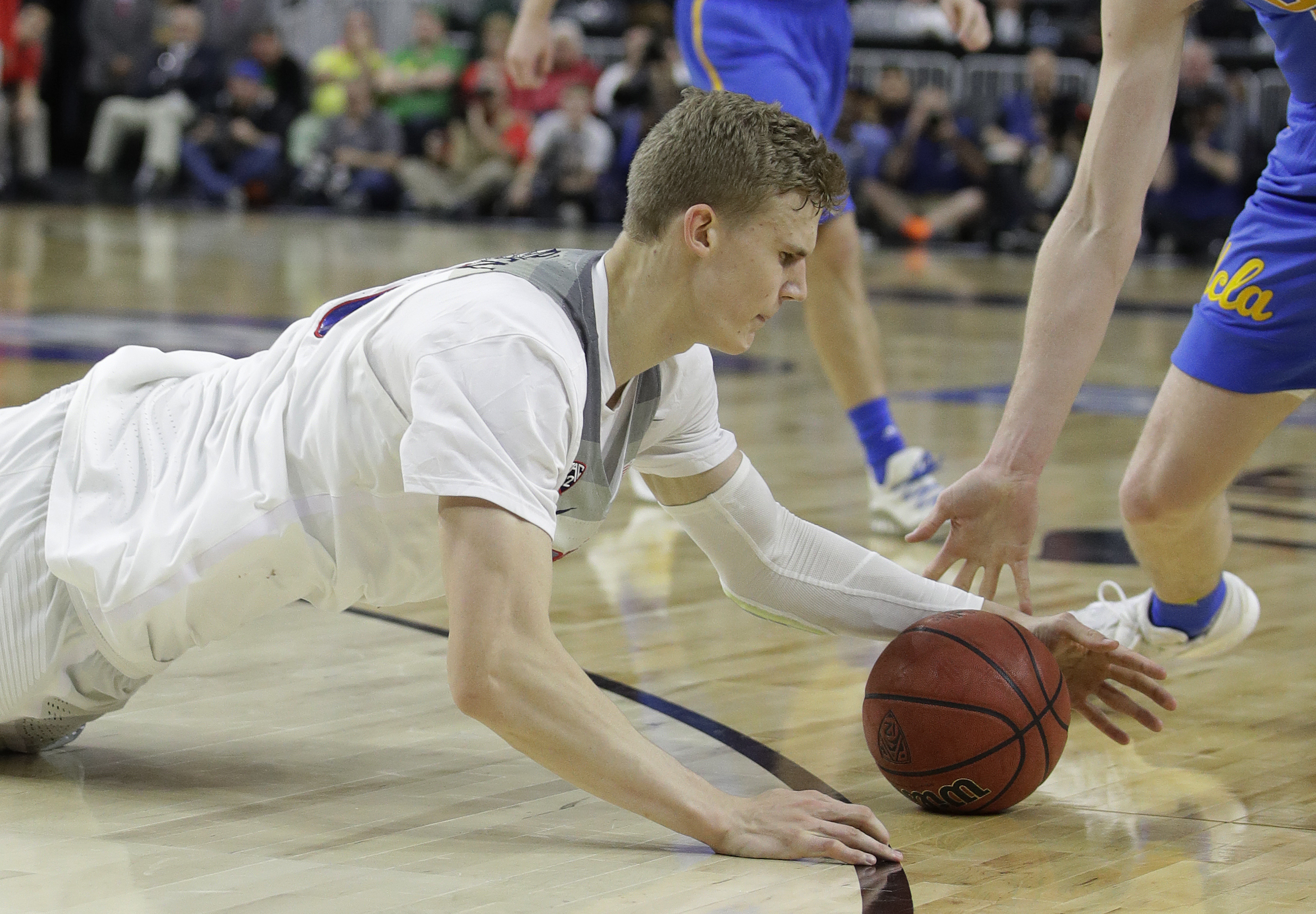 Arizona's Lauri Markkanen scrambles for the ball during the second half of the team's NCAA college basketball game against UCLA in the semifinals of the Pac-12 men's tournament Friday, March 10, 2017, in Las Vegas. Arizona won 86-75. (John Locher, AP Photo, File)