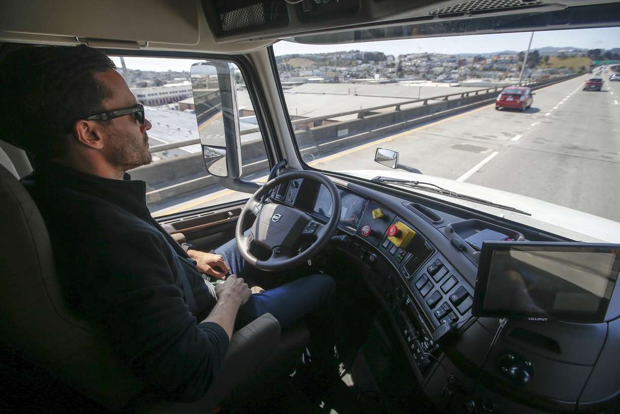 Matt Grigsby, senior program engineer at Otto, takes his hands off the steering wheel of a self-driving, big-rig truck during a demonstration on the highway, in San Francisco. Photo: Associated Press