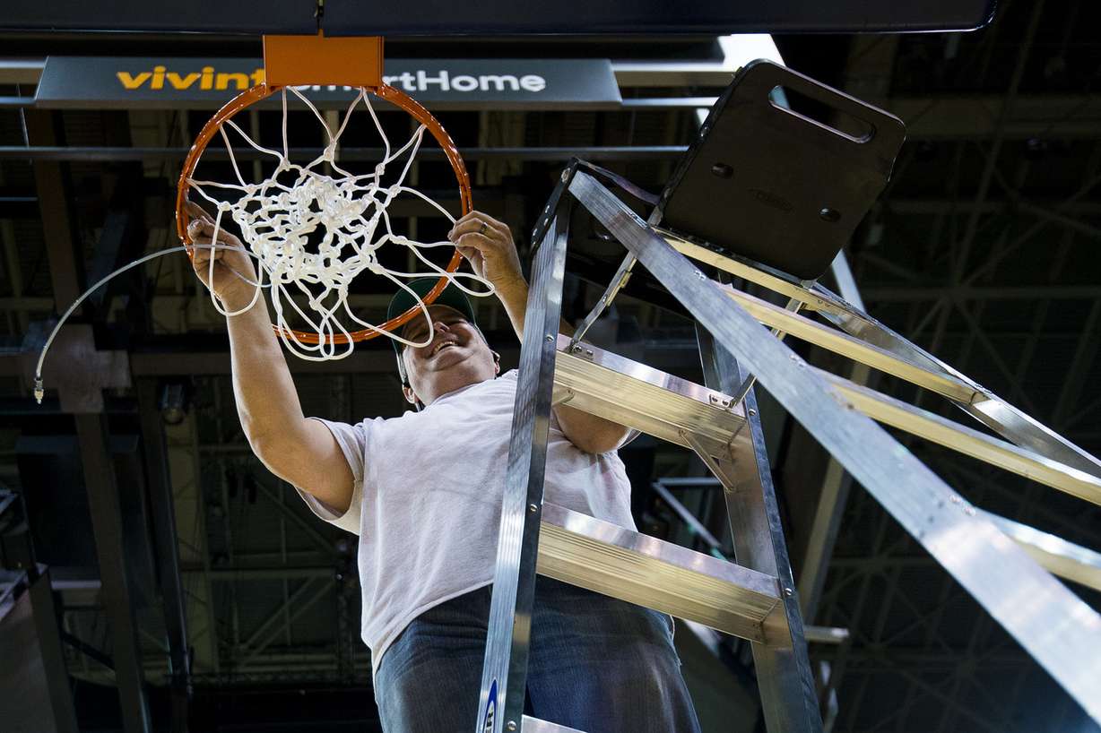 Justin Greening, a member of Spalding's install team, sets up a net at Vivint Smart Home Arena in Salt Lake City on Tuesday, March 14, 2017, in preparation for the first and second rounds of the 2017 NCAA men's basketball tournament on Thursday and Saturday. Photo: Alex Goodlett, Deseret News