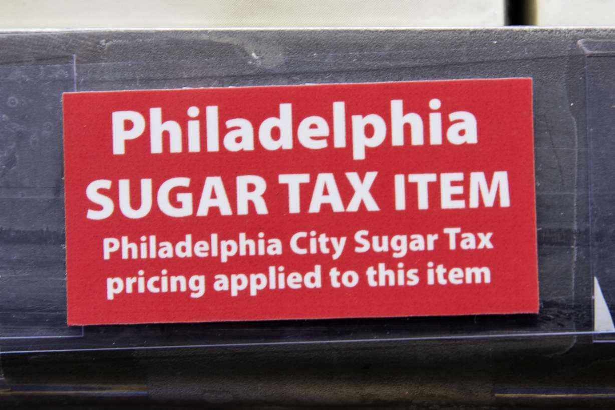 Sticker alerts customers of the sugar tax posted by sweetened beverages at the IGA supermarket in the Port Richmond neighborhood of Philadelphia. Photo: AP Photo