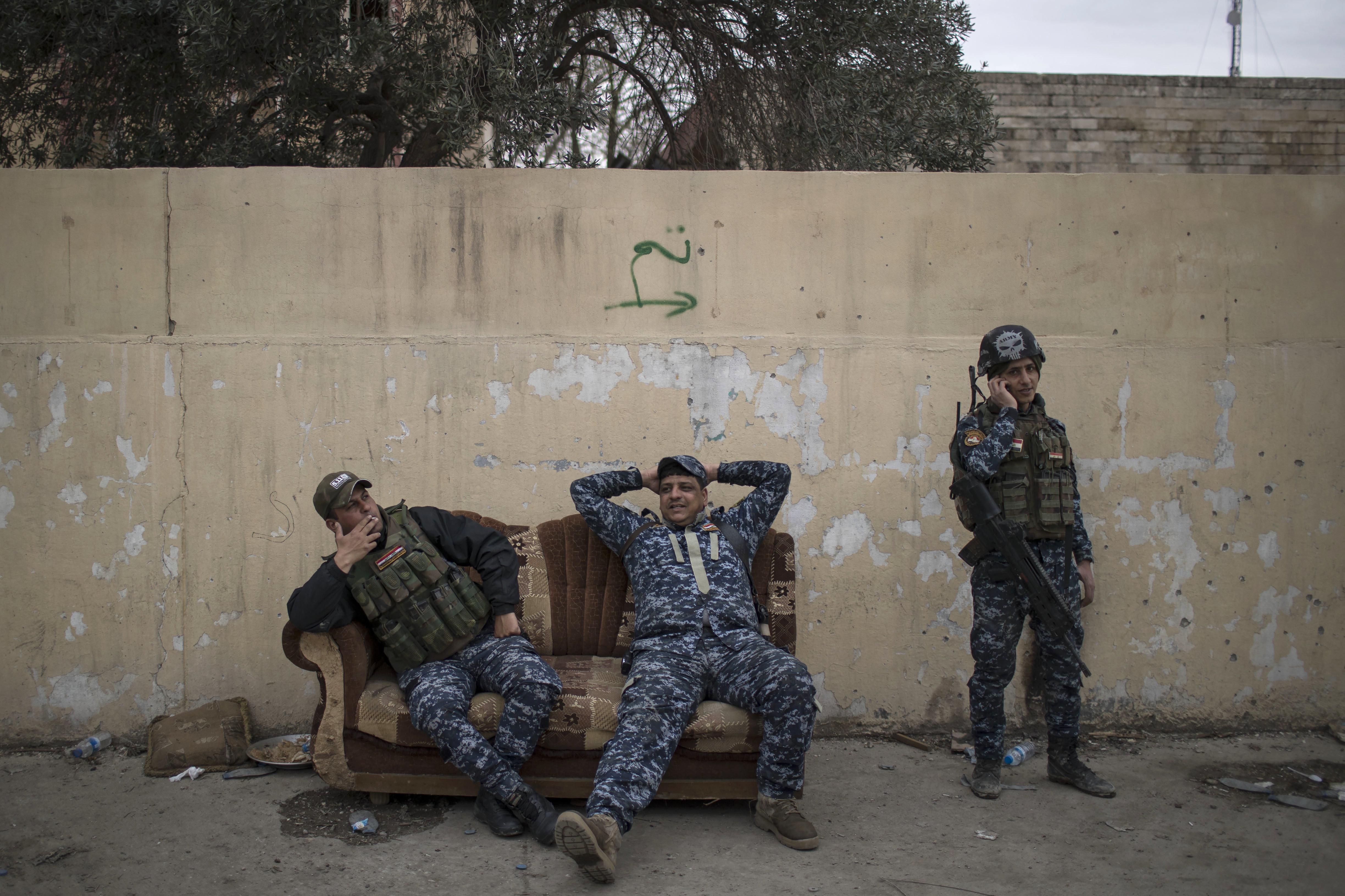 Federal Police officers rest on a couch during fighting between Iraqi security forces and Islamic State militants, on the western side of Mosul, Iraq, Sunday, March 19, 2017. The battle for western Mosul, including the narrow alleyways of the old city, looks to be the most devastating yet for Iraqi civilians trapped between advancing troops and increasingly desperate Islamic State militants. An estimated 750 civilians have been killed or wounded since the push to retake the western half of the city began in late January, and more than 100,000 have fled. (Photo: Felipe Dana, Associated Press)