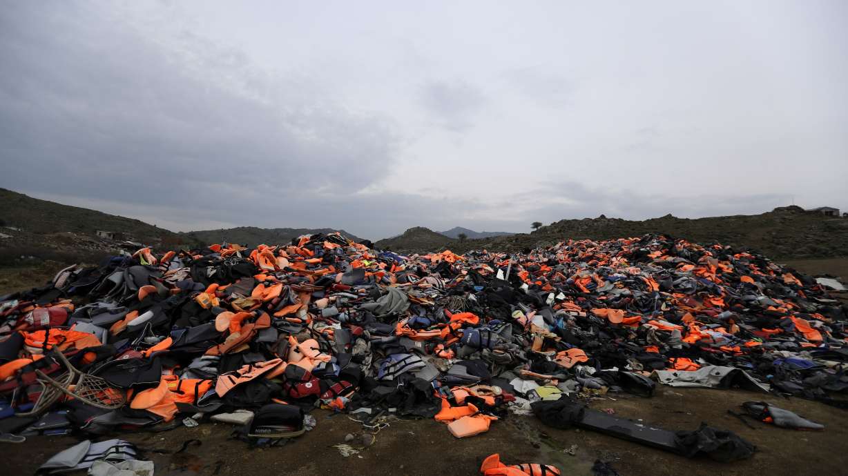 The Latest: EU praises year-old migrant deal with Turkey