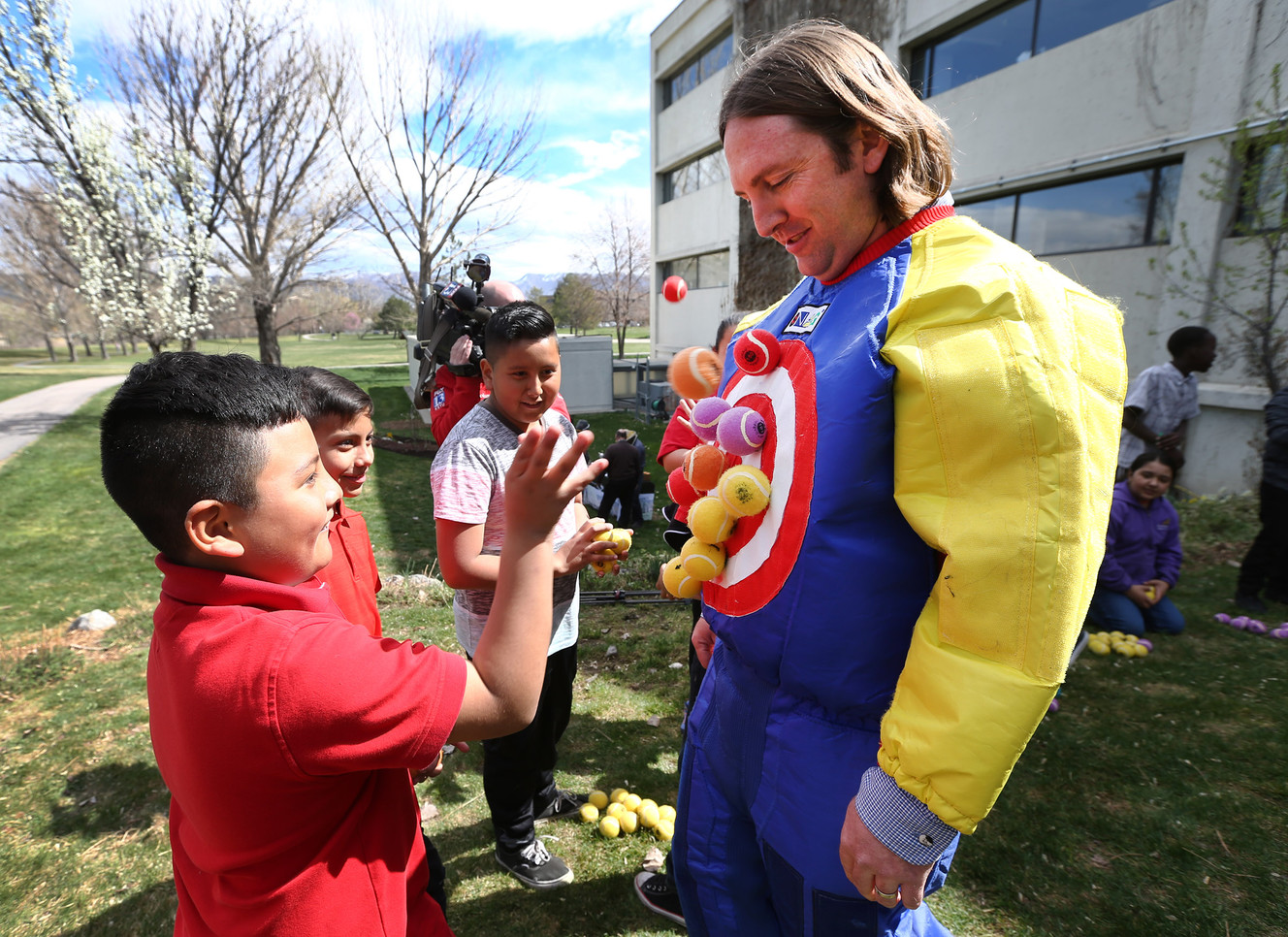 Jesus Bustmante tosses a tennis ball onto a Velcro target worn by Kristopher Watson, insect program manager at the Utah Department of Agriculture and Food. Photo: Scott G Winterton, Deseret News