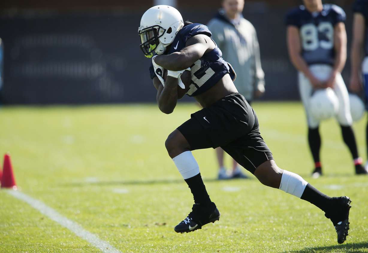 BYU running back Squally Canada (22) carries the ball through a hole during football practice in Provo. (Photo: Nick Wagner, Deseret News, File)