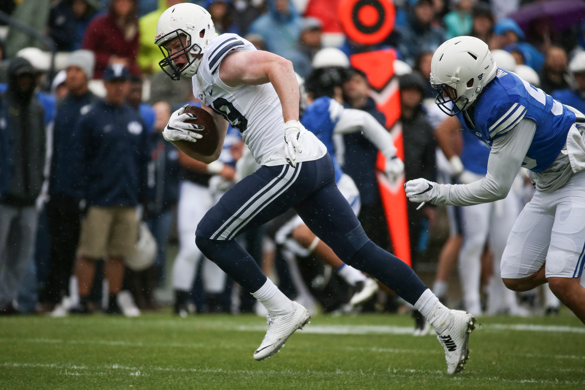 Tight end Matt Bushman runs ahead of offensive lineman Thomas Shoaf during the BYU football spring practice and scrimmage at LaVell Edwards Stadium in Provo on Saturday, March 25, 2017. (Photo: Spenser Heaps, Deseret News)