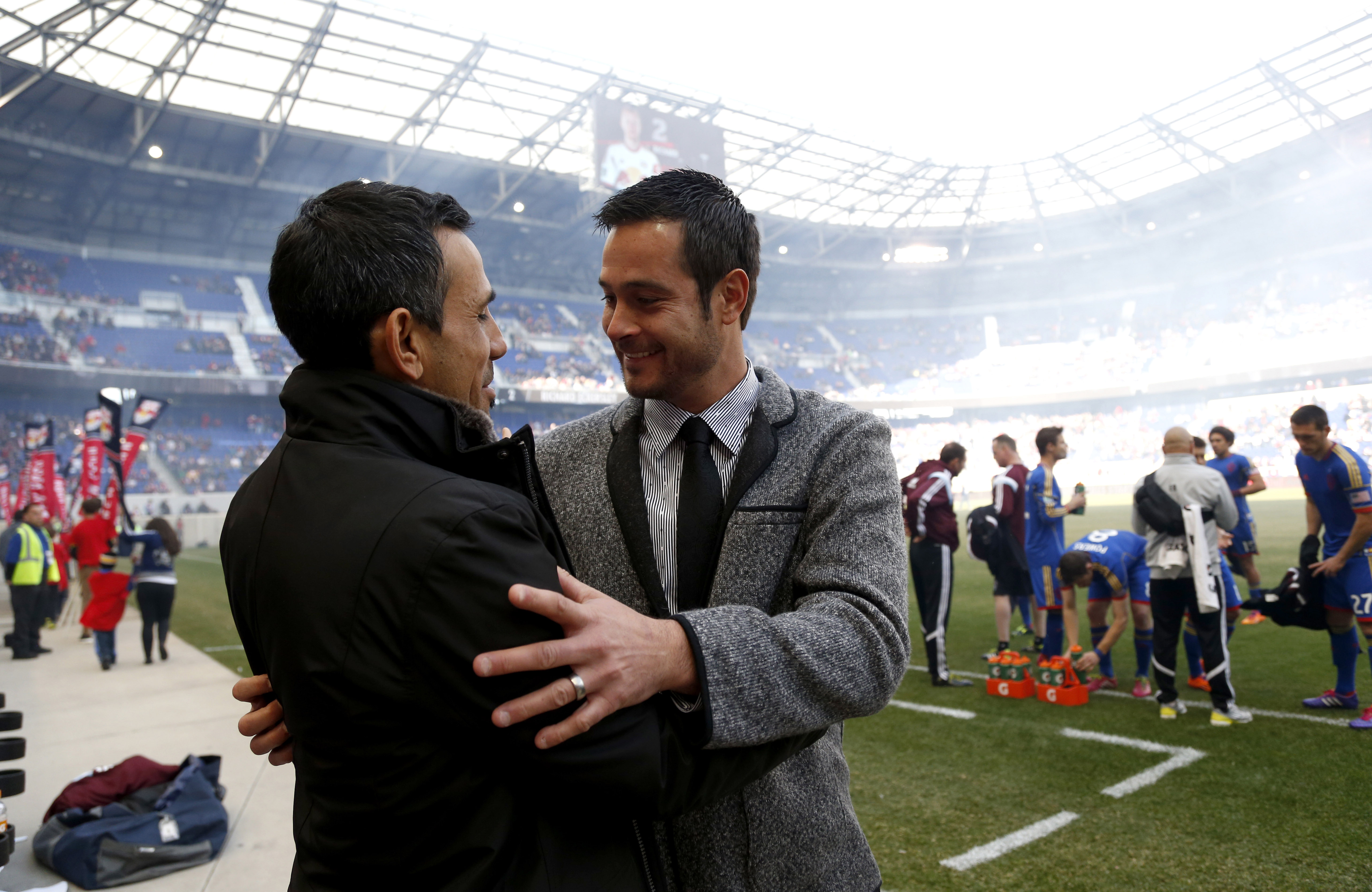 New York Red Bulls head coach Mike Petke, right, talks to Colorado Rapids head coach Pablo Mastroeni before the start of an MLS soccer game, Saturday, March 15, 2014, in Harrison, N.J. Mastroeni was installed as Real Salt Lake manager Monday after serving as the club's interim coach for the last four months.