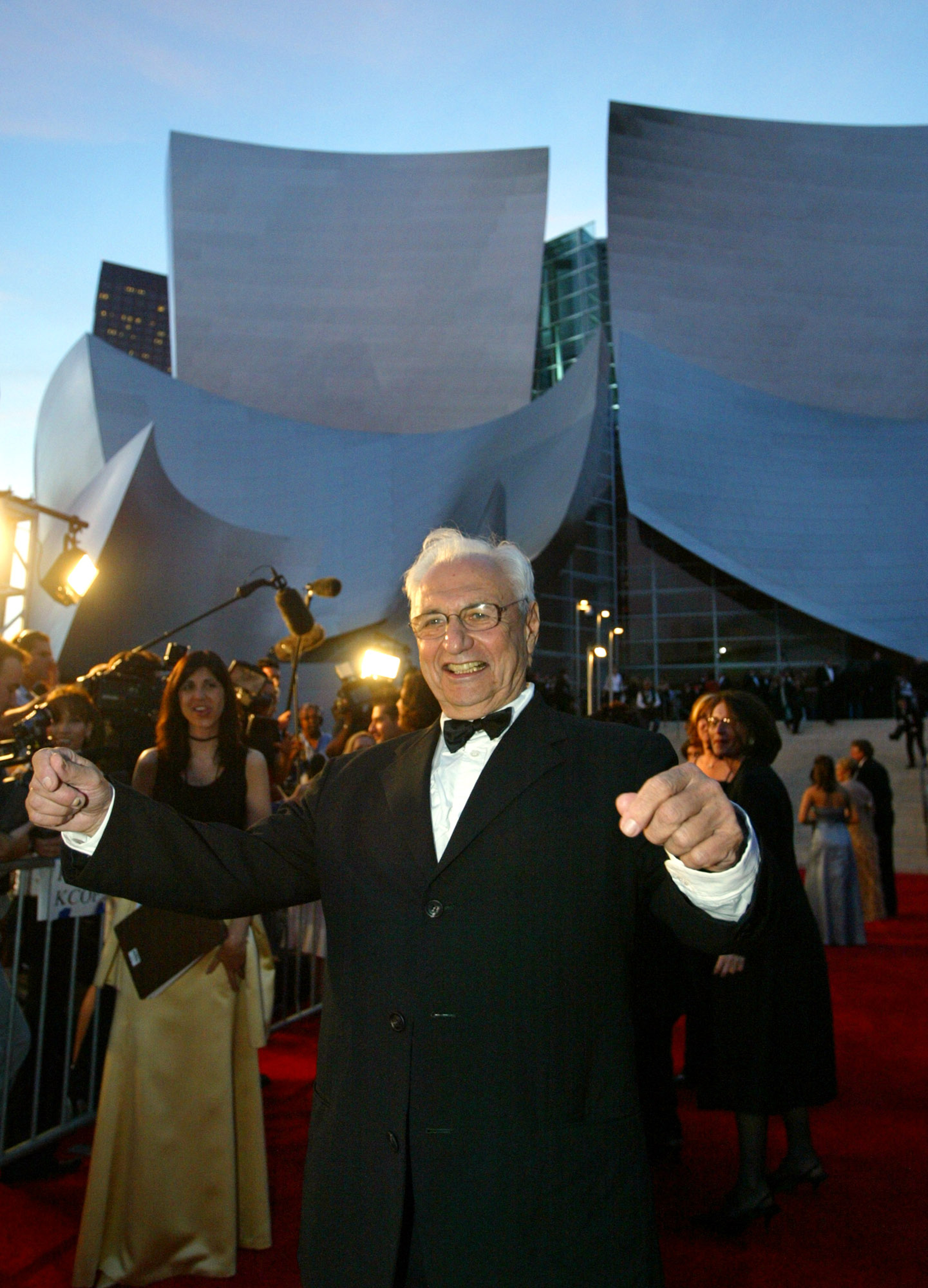 Frank Gehry stands in front of the Walt Disney Concert Hall on Oct. 23, 2003. It was one of several notable works for Gehry, who died Friday at age 96.