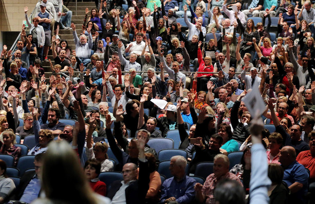 After being asked to show by a raise of hands who doesn't want the homeless center, angry Draper residents raise their hands for Draper Mayor Troy Walker and Salt Lake County Mayor Ben McAdams during a meeting at Draper Park Middle School on Wednesday, March 29, 2017. (Photo: Scott G Winterton, Deseret News)