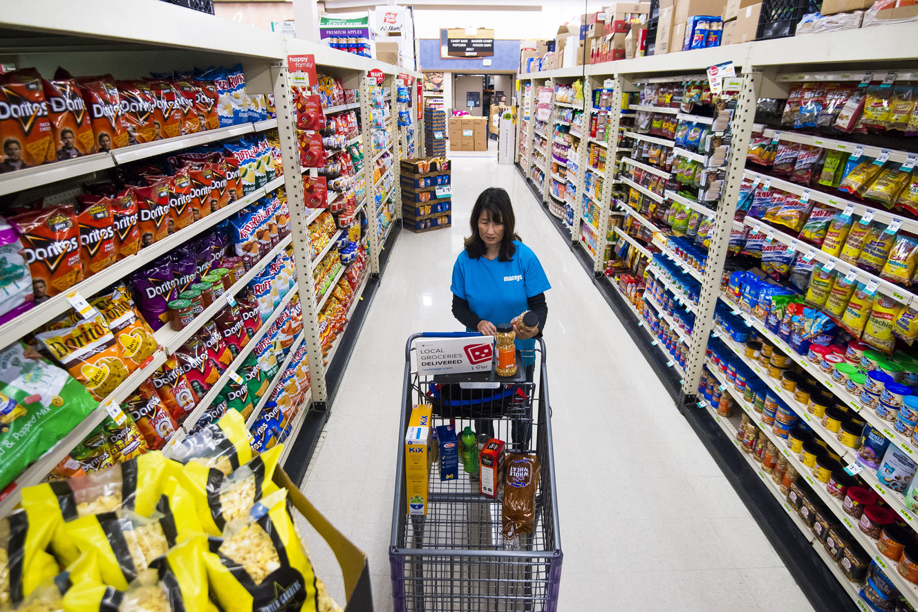 Kaili Walker, a personal shopper for the Macey's curbside and delivery services, fulfills an online grocery order at the store in Sandy on Monday, April 3, 2017. (Photo: Alex Goodlett, Deseret News)