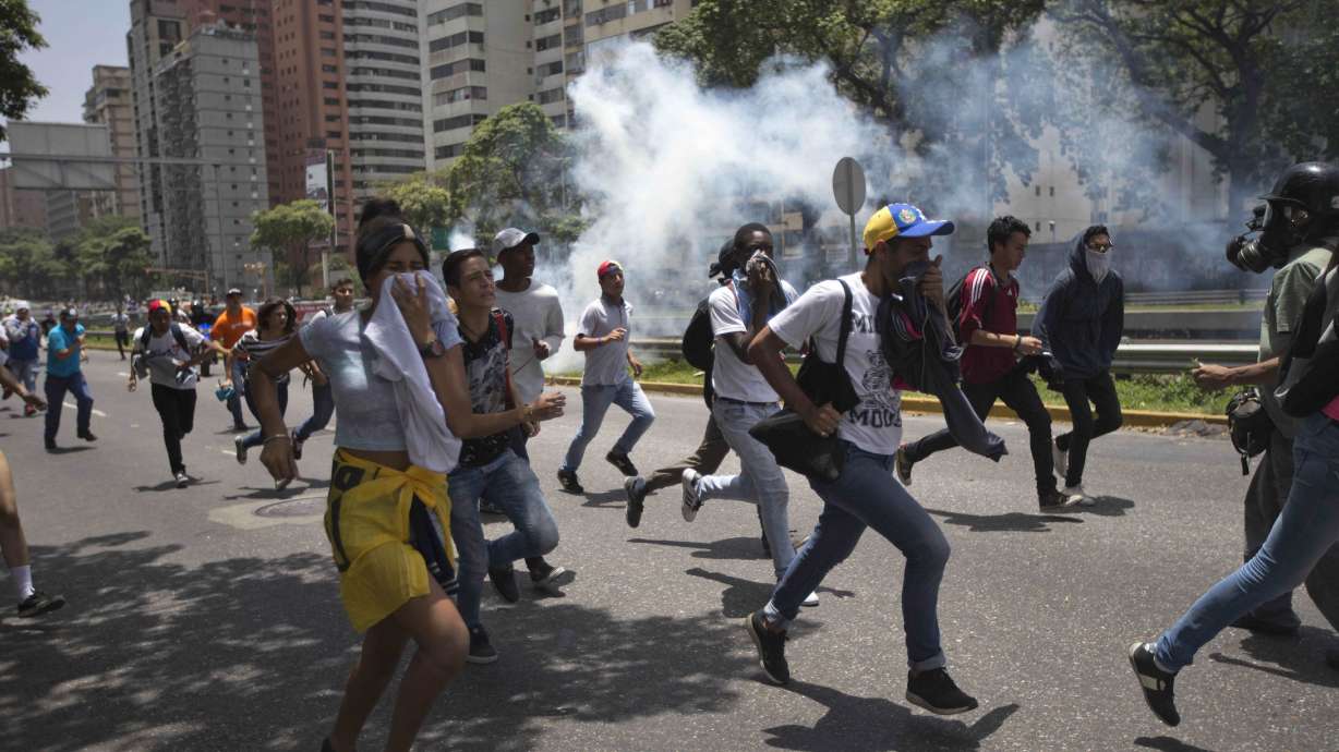 Police fire pepper spray at opposition march in Venezuela