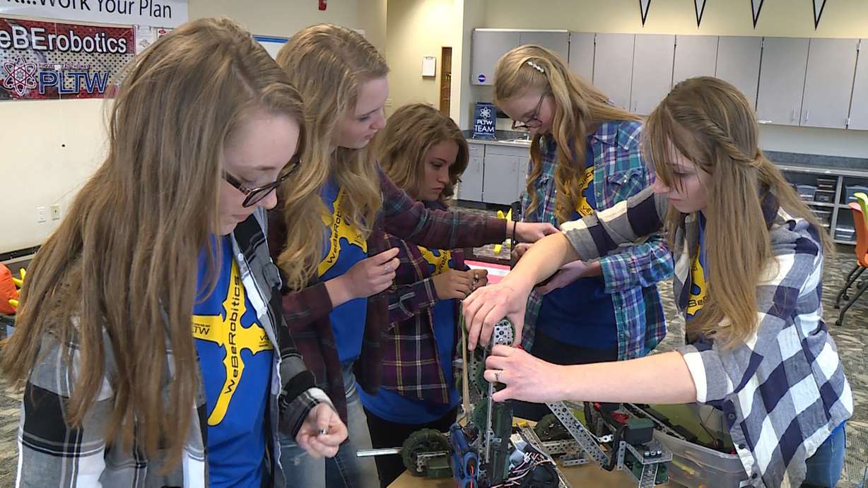 The team works together to solve a problem with their robot. (Photo: Ray Boone)
