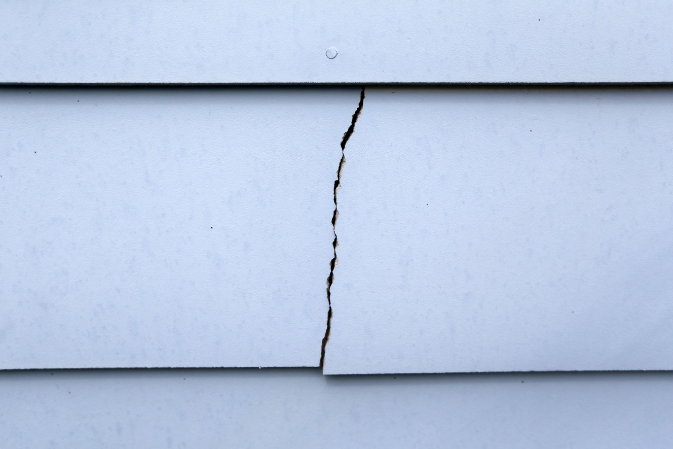 One of many cracks in the siding on Mason Emerson's Daybreak town house is pictured on Tuesday, April 11, 2017, in South Jordan. (Photo: Kristin Murphy, Deseret News)