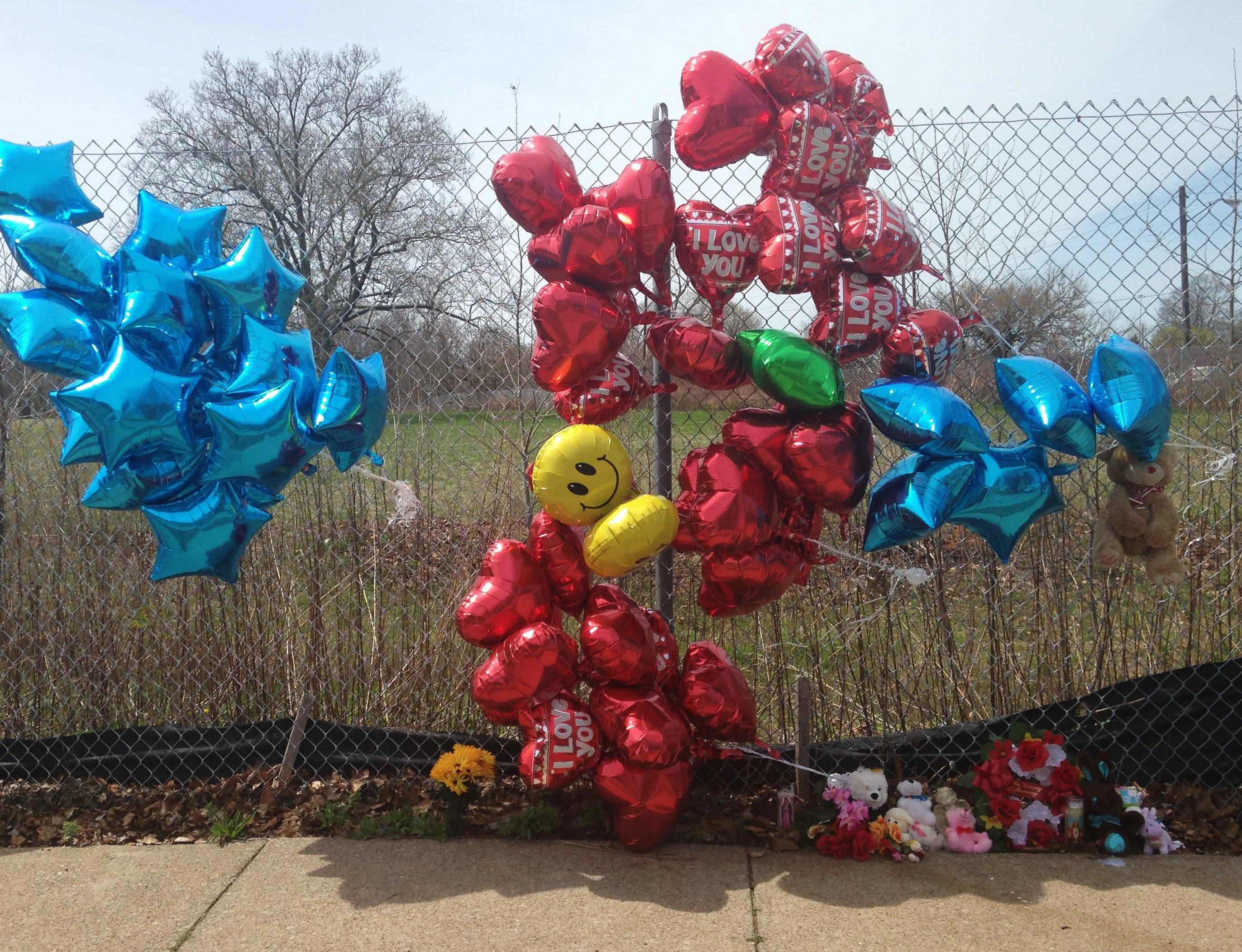A makeshift memorial sits along a fence Monday, April 17, 2017, near where Robert Godwin Sr., was killed in Cleveland. Police said Steve Stephens killed Godwin on Sunday and posted the video on Facebook. (AP Photo/Mike Householder)
