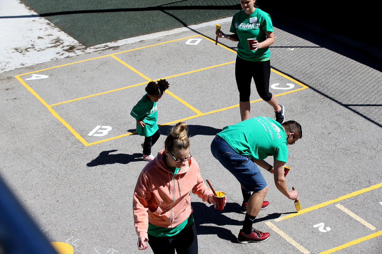 Fidelity Investments employees and their families paint the playground of West High School's day care during Transformation Day in Salt Lake City on Saturday, April 22, 2017. West High School is the oldest public high school in Utah. (Photo: Laura Seitz, Deseret News)
