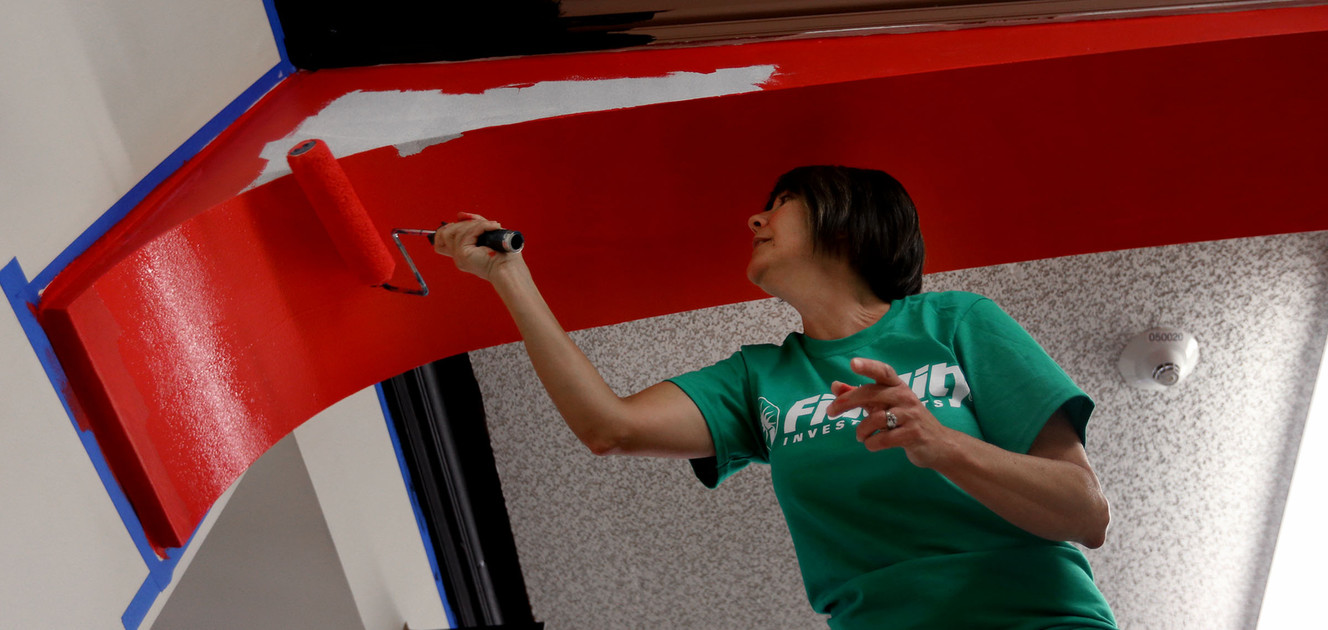 Marilyn Colgan, of Salt Lake City, paints arches in a hallway at West High School, the oldest public high school in Utah, as part of Transformation Day in Salt Lake City on Saturday, April 22, 2017. Fidelity Investments employee volunteers and their families worked to reinvigorate the school's interior and exterior. (Photo: Laura Seitz, Deseret News)