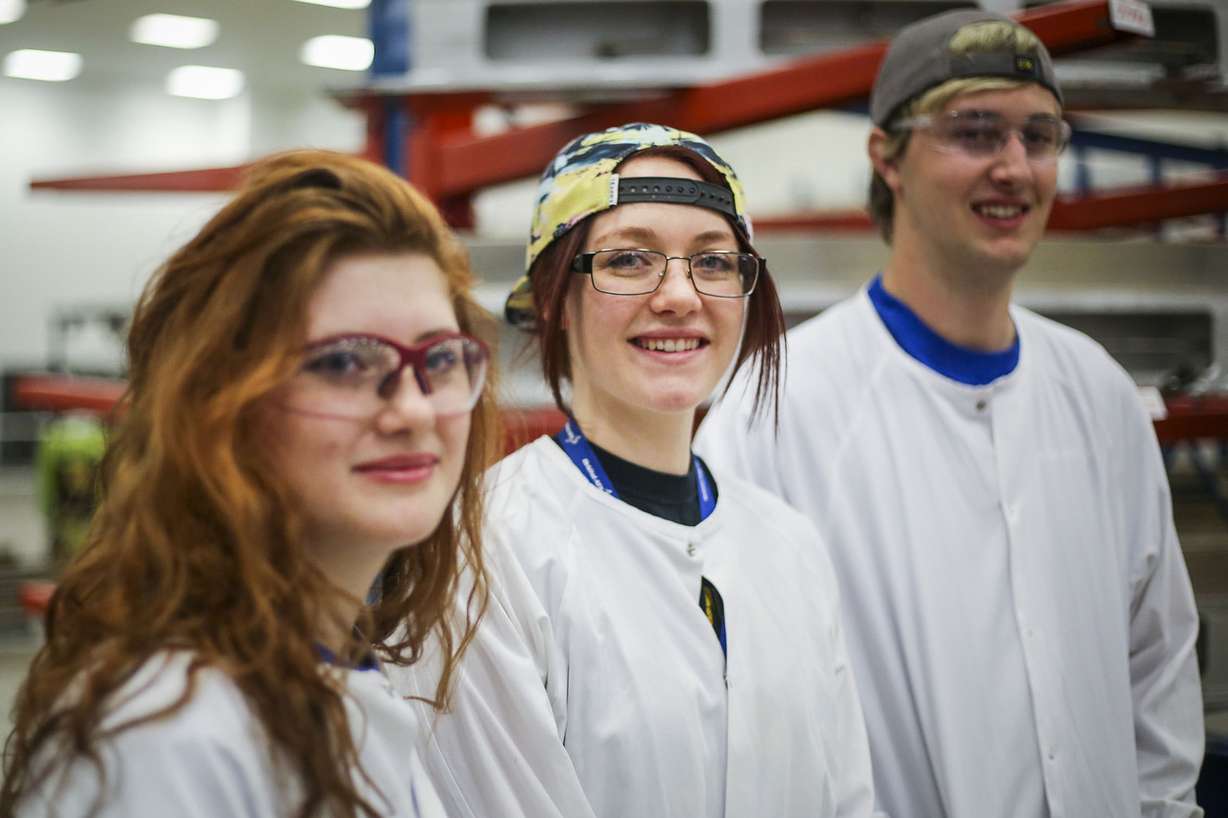 Mychala Sandberg, middle, stands with trainees, Katlynn Simpson, left, and Ben Larsen, right, members of the Utah Aerospace Pathways Program, in the radial room at the Orbital ATK manufacturing facility in Clearfield on Thursday, April 20, 2017. (Photo: Nicole Boliaux, Deseret News)