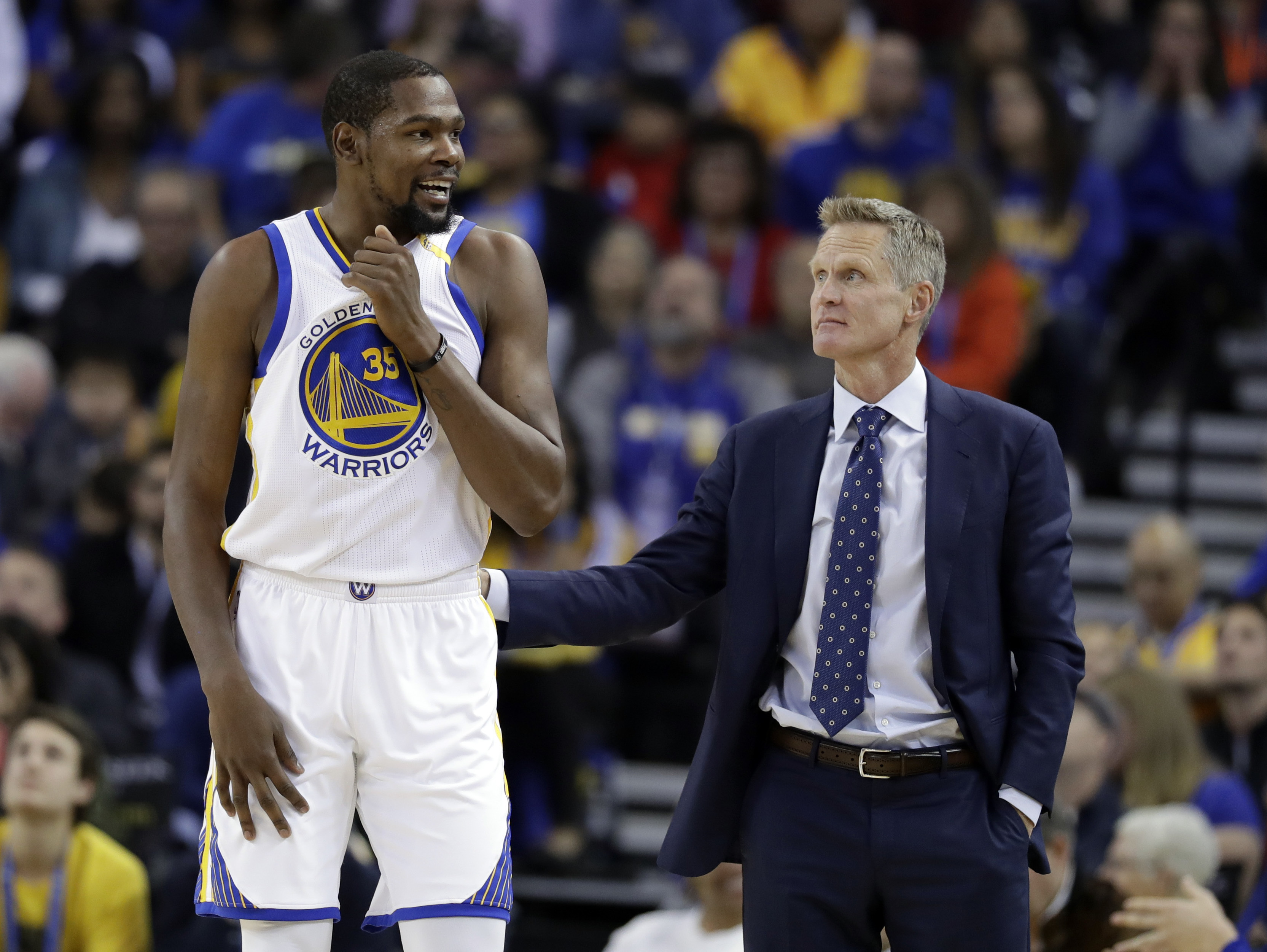 In this Nov. 23, 2016, file photo, Golden State Warriors' Kevin Durant, left, talks with coach Steve Kerr during the team's NBA basketball game against the Los Angeles Lakers in Oakland, Calif. (AP Photo)