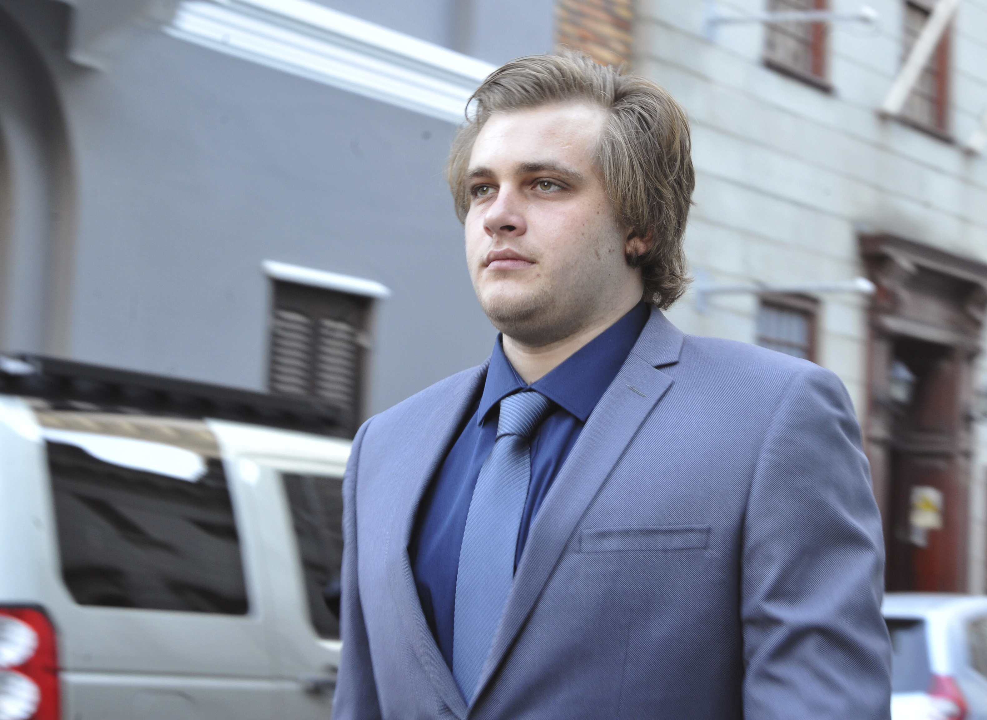 South African suspect in ax murders is taken to crime scene