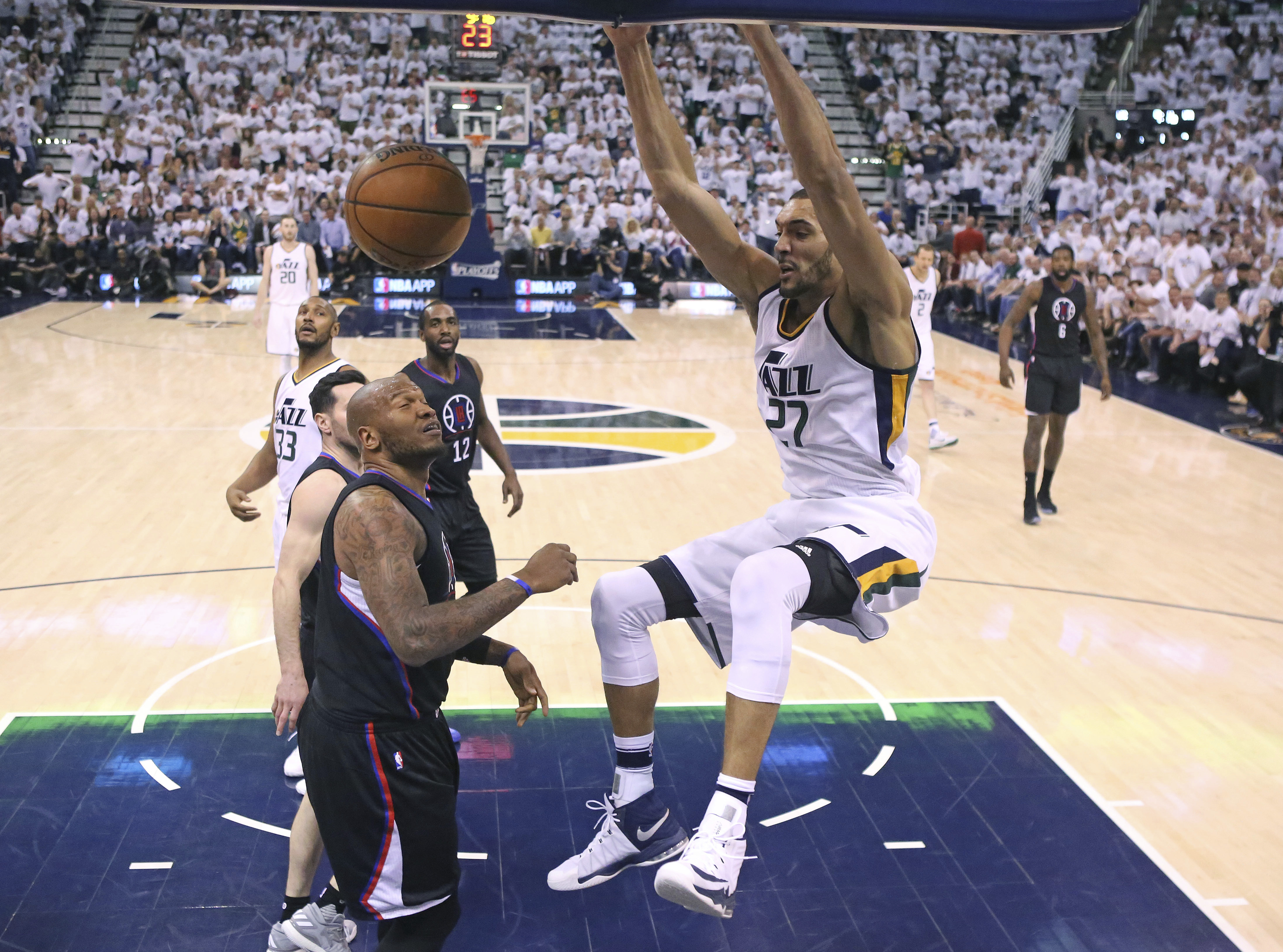Utah Jazz center Rudy Gobert (27) dunks the ball on Los Angeles Clippers center Marreese Speights, left, during the second half in Game 4 of an NBA basketball first-round playoff series Sunday, April 23, 2017, in Salt Lake City. The Jazz won 105-98. (Rick Bowmer, AP Photo)