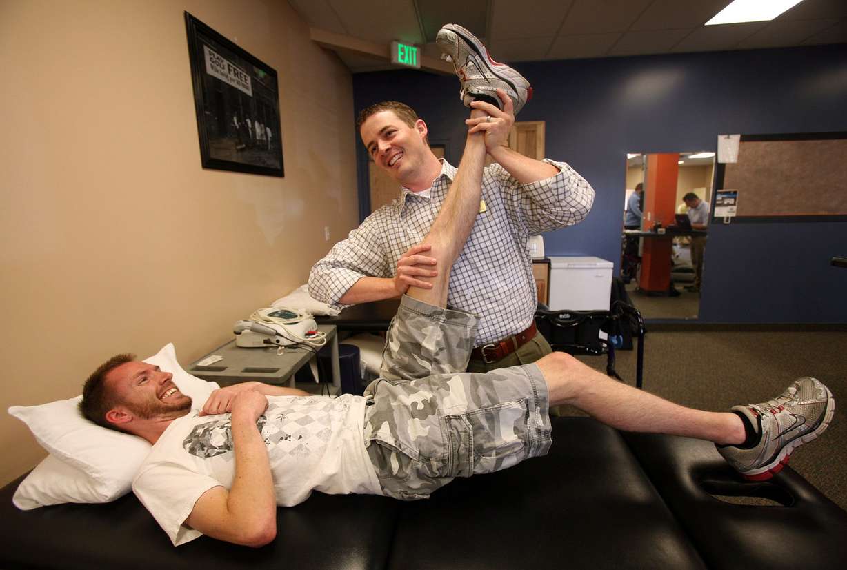Bob Welker gets help stretching out his legs at Mountain Lands Physical Therapy in Sandy in 2013. (Photo: Kristin Murphy, Deseret News)