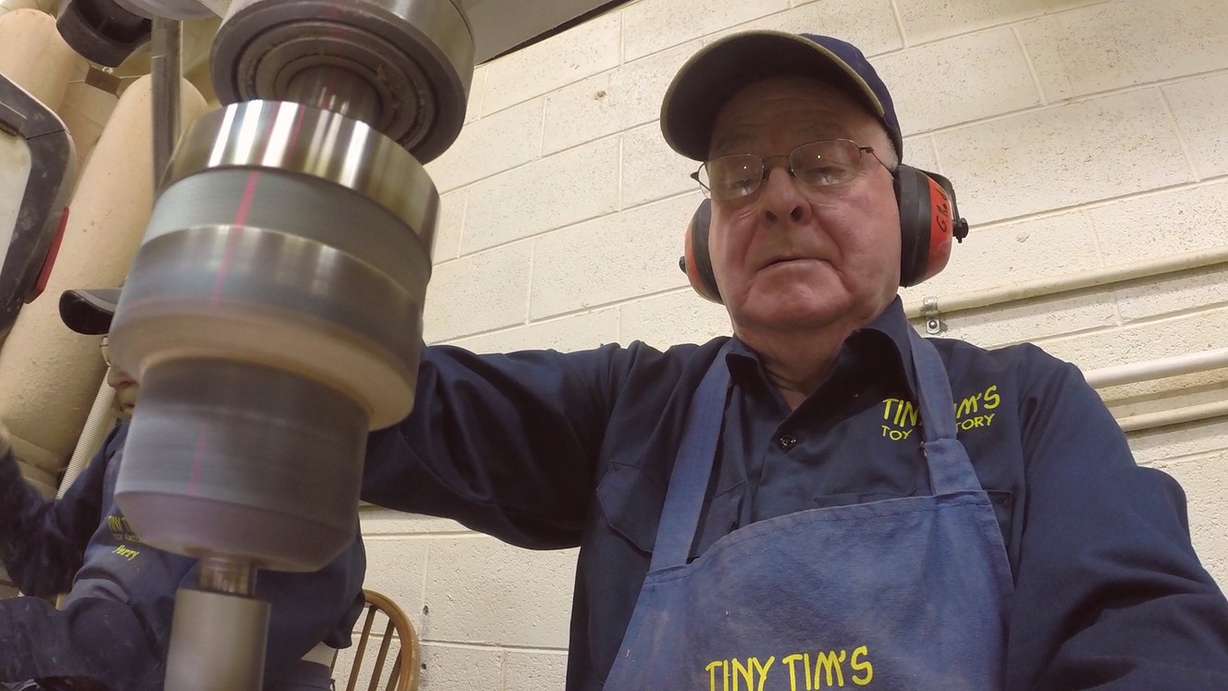 A volunteer drills holes in a toy car at Tiny Tim's Toy Factory. (Photo: Ray Boone)