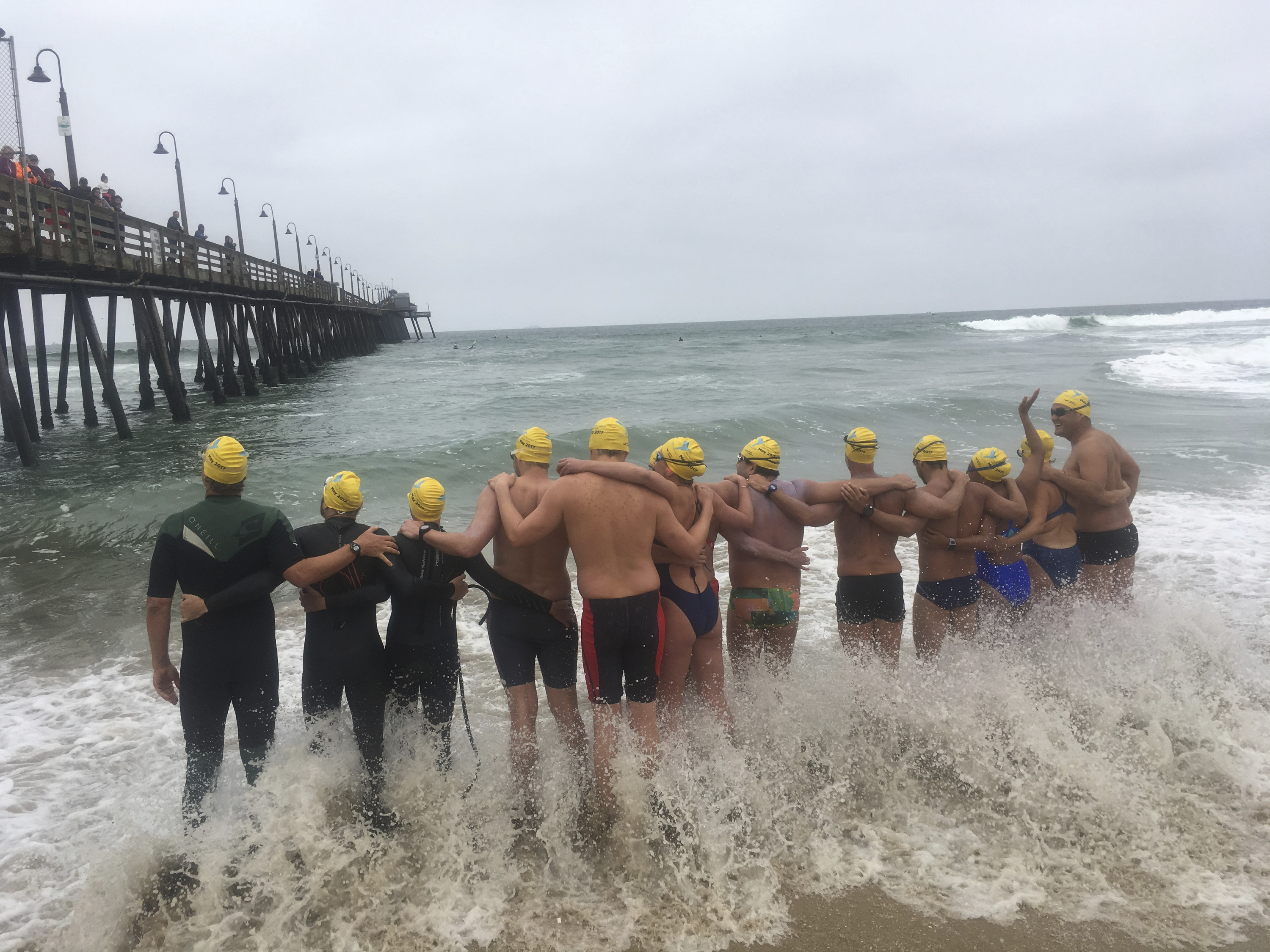 Athletes from six countries join arms before swimming off from Imperial Beach, Calif., to Mexico, in what they say is a show of solidarity with immigrants on Friday, May 5, 2017. The swimmers from the United States, Mexico, Israel, New Zealand and South Africa were escorted by a Mexican Navy ship as they reached a beach in Tijuana, a short distance from a border fence that juts into the Pacific Ocean. (AP Photo/Elliot Spagat)