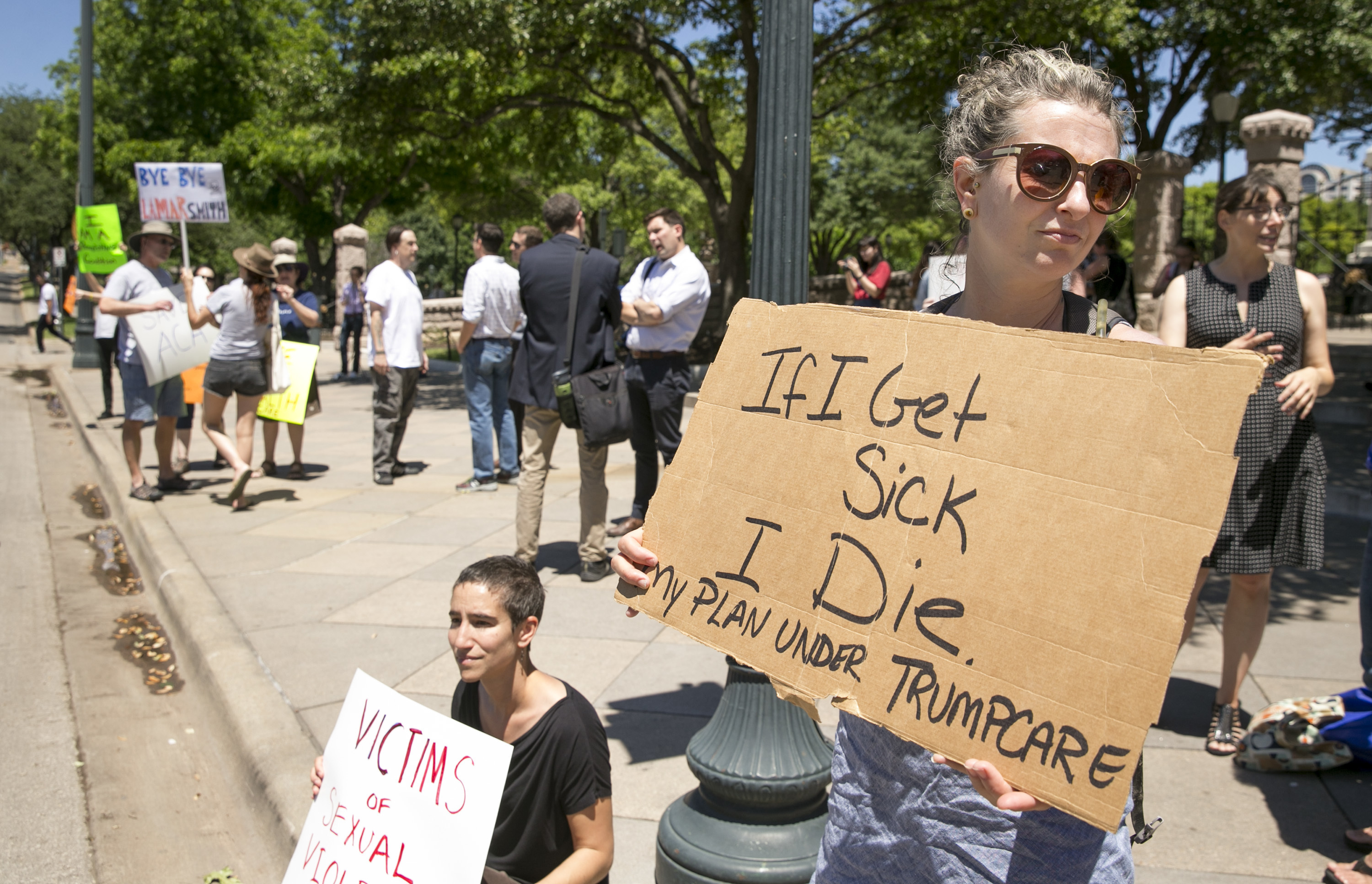 FILE - In this Friday May 5, 2017 file photo, Sophia Donnelly joins others to protest the U.S. House passage of a bill to repeal and replace the Affordable Care Act, at the south gate of the Capitol in Austin, Texas. On Friday, Republican Gov. Greg Abbott spokesman John Wittman said, "Congress’ efforts to repeal and replace Obamacare is a step toward ending the lawless health care regime that failed to live up to its promises and is spiraling to a hasty death." (Jay Janner/Austin American-Statesman via Associated Press)