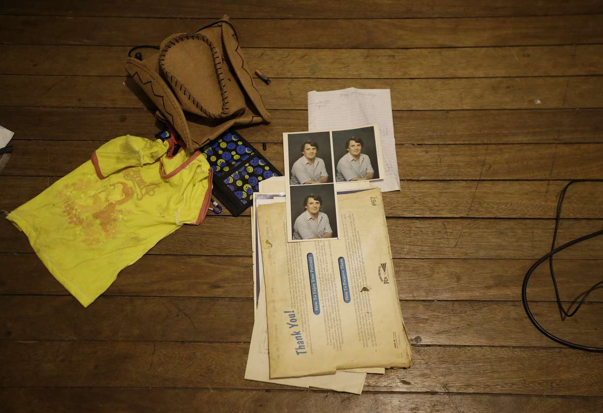 A young girl's shirt, a cowboy hat and pictures of suspected child webcam cybersex operator, David Timothy Deakin, from Peoria, Ill., lay on the floor during a raid in Mabalacat, Philippines. Photo: AP Photo