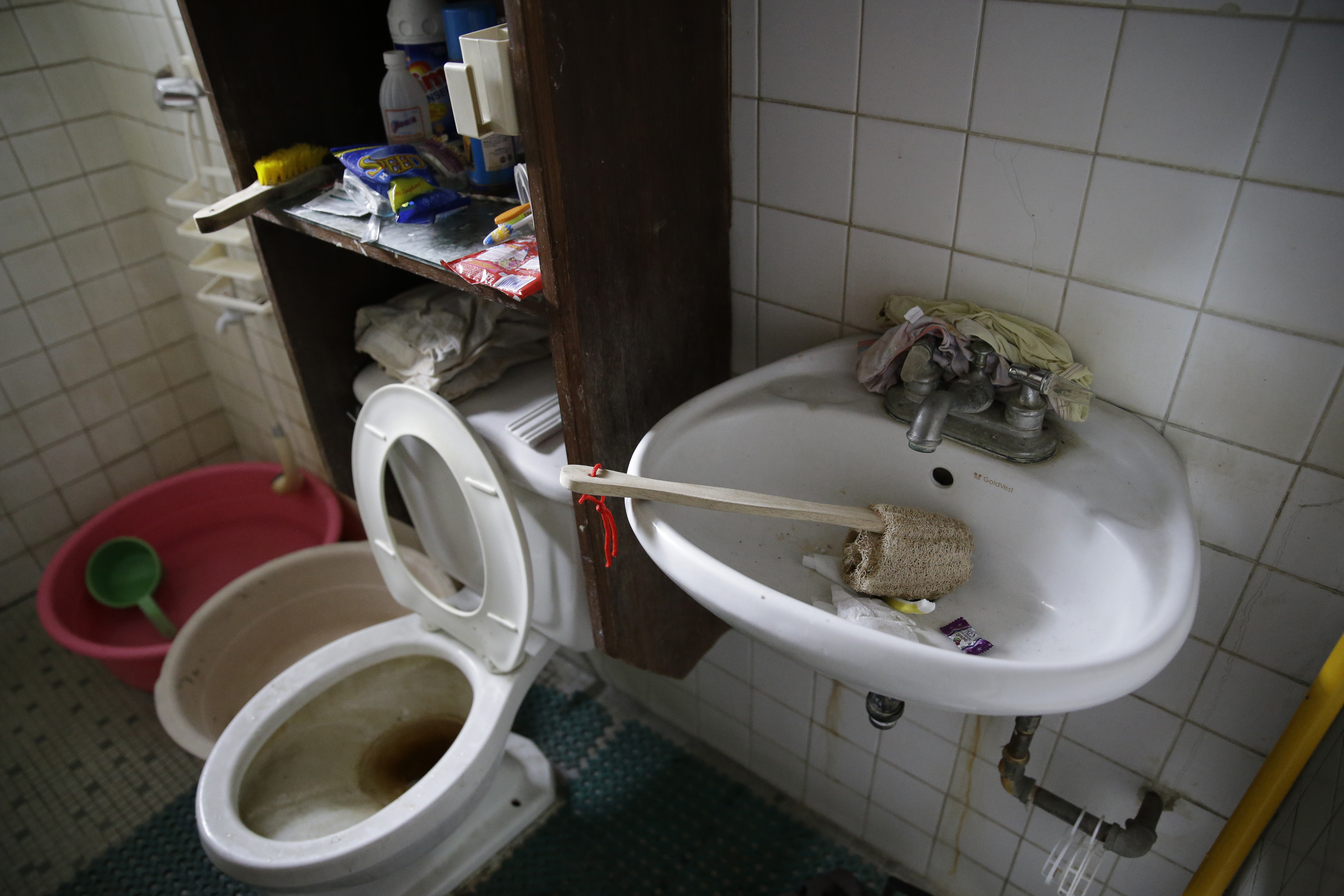 Underwear is wedged behind the faucet of the bathroom sink inside the home of suspected child webcam cybersex operator, David Timothy Deakin, from Peoria, Ill., during a raid in Mabalacat, Philippines. Photo: AP Photo