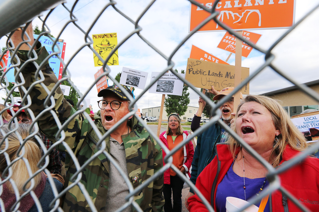 Paul and Lieslie Williams of New Harmony in Washington County join other supporters of the Grand Staircase-Escalante National Monument chanting "talk to us" to Interior Secretary Ryan Zinke at the airport in Kanab on Wednesday. (Photo: Scott G Winterton, Deseret News)