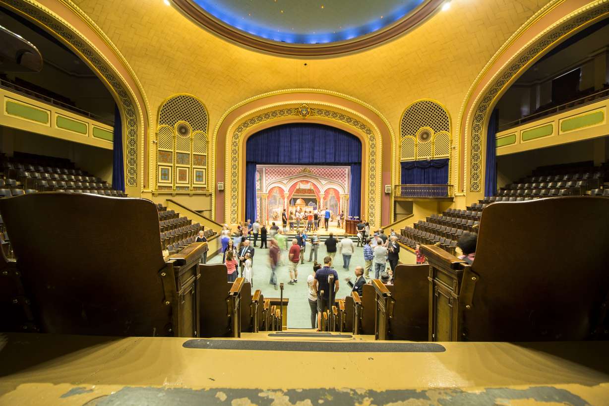 A group of people check out the Auditorium inside the Salt Lake Masonic Temple on May 6, 2017. The room, architect Carl W. Scott wrote, was intended for larger gatherings and has less seen Masonic significance than other rooms because it is the room "which the public is frequently admitted." Scott notes "the magnesium glow lights in the dome are intended to symbolize the canopy of heaven. The curtains, which can be drawn across the four arches, converting the cross-shaped room into a more compact space, are of dyed Repp, and depict the workman in the forest, quarry, and at the site constructing King Solomon's Temple."