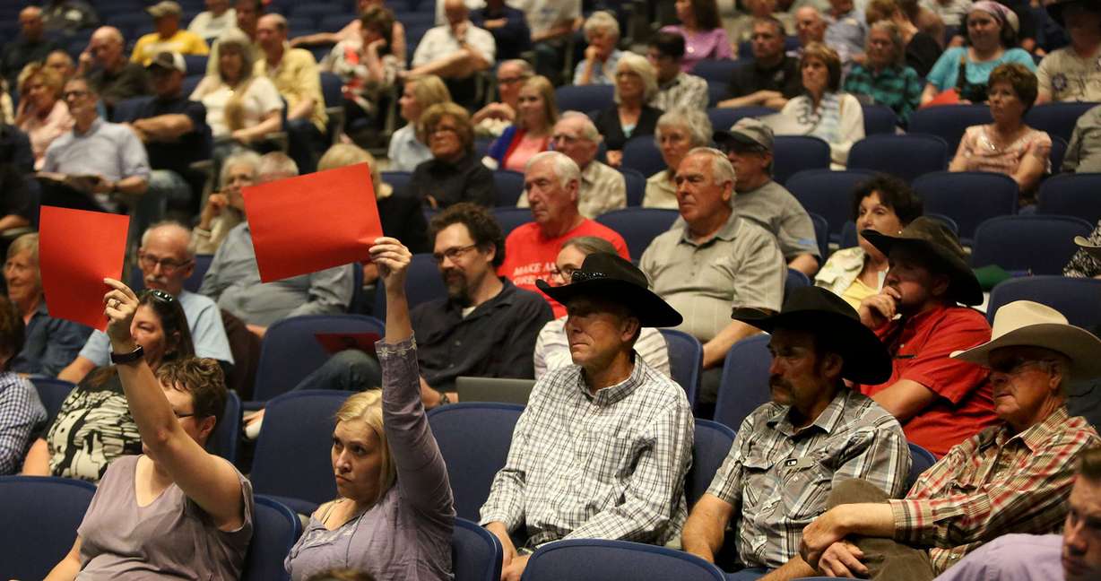 Tracie Parry, from West Valley City, and Nicole Peterson, who grew up in Richfield and now lives in Salt Lake City, hold up red paper to show that they disagree with Rep. Chris Stewart's claim that Planned Parenthood spent most of its money on abortions. (Photo: Kristin Murphy, Deseret News)