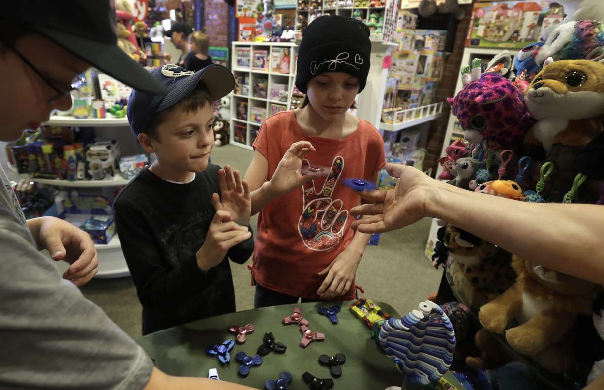 Customers look over the selection of fidget spinners at the Funky Monkey Toys store in Oxford, Mich. Photo: AP Photo