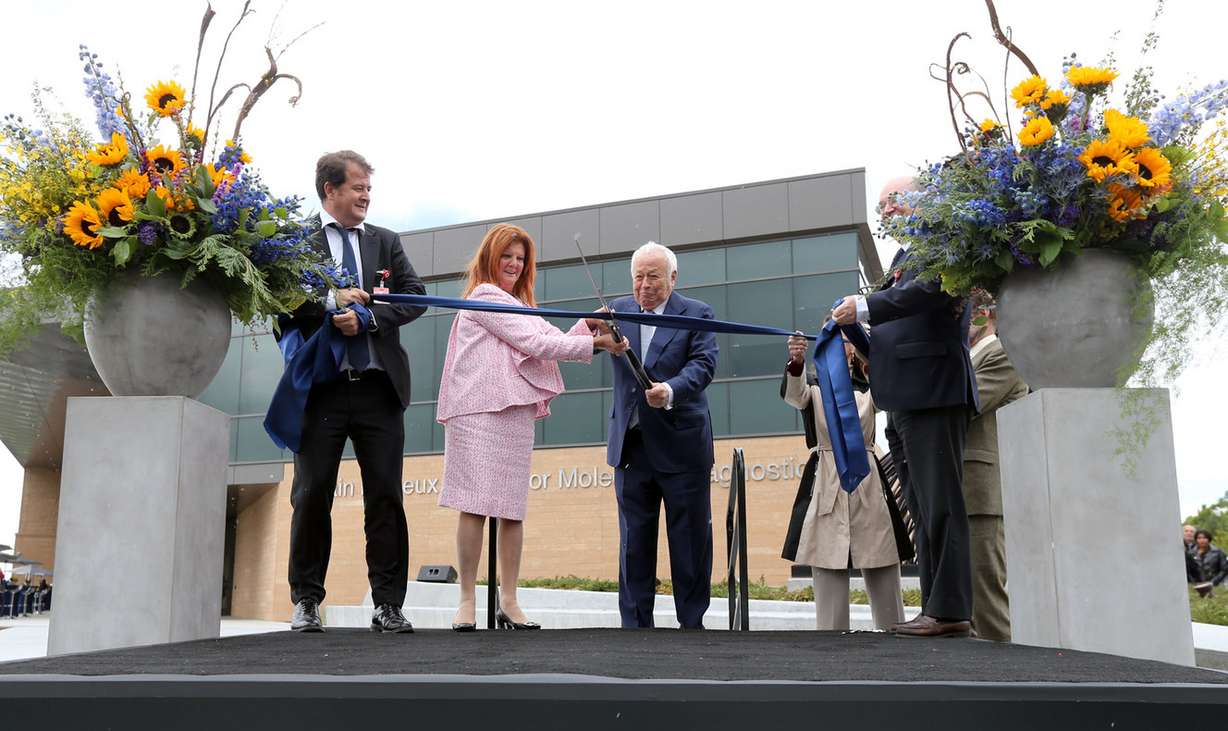 Alexandre Mérieux, CEO of bioMérieux, Chantel Mérieux, Alain Mérieux, bioMérieux founder, and Jean-Luc Belingard, chairman of bioMérieux, cut the ribbon for the Alain Mérieux Center for Molecular Diagnostics in Salt Lake City on Wednesday, May 17, 2017. (Photo: Kristin Murphy, Deseret News)