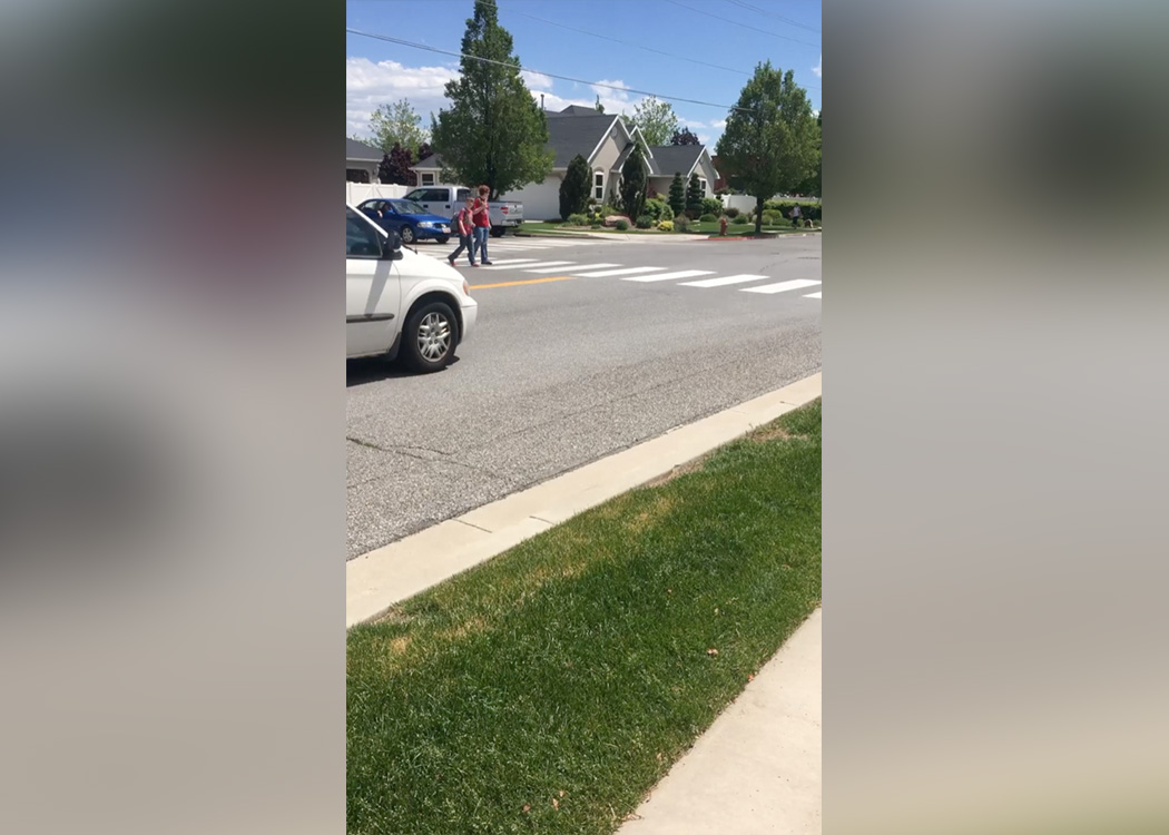 Children walk in a crosswalk located at 2875 North and 300 West in Lehi as a minivan passes by. (Photo: Heather Newall)