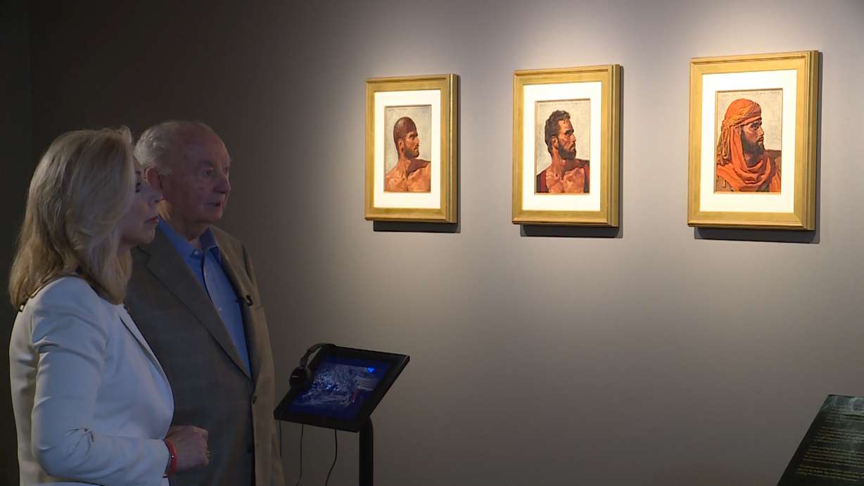 BYU donor Rex Maughan and KSL's Carole Mikita look at recently discovered paintings created by the late Arnold Friberg for the 1956 film "The Ten Commandments." The Utah artist's paintings are on exhibit at BYU's Special Collections Library. (Photo: Steve Landeen, KSL TV)
