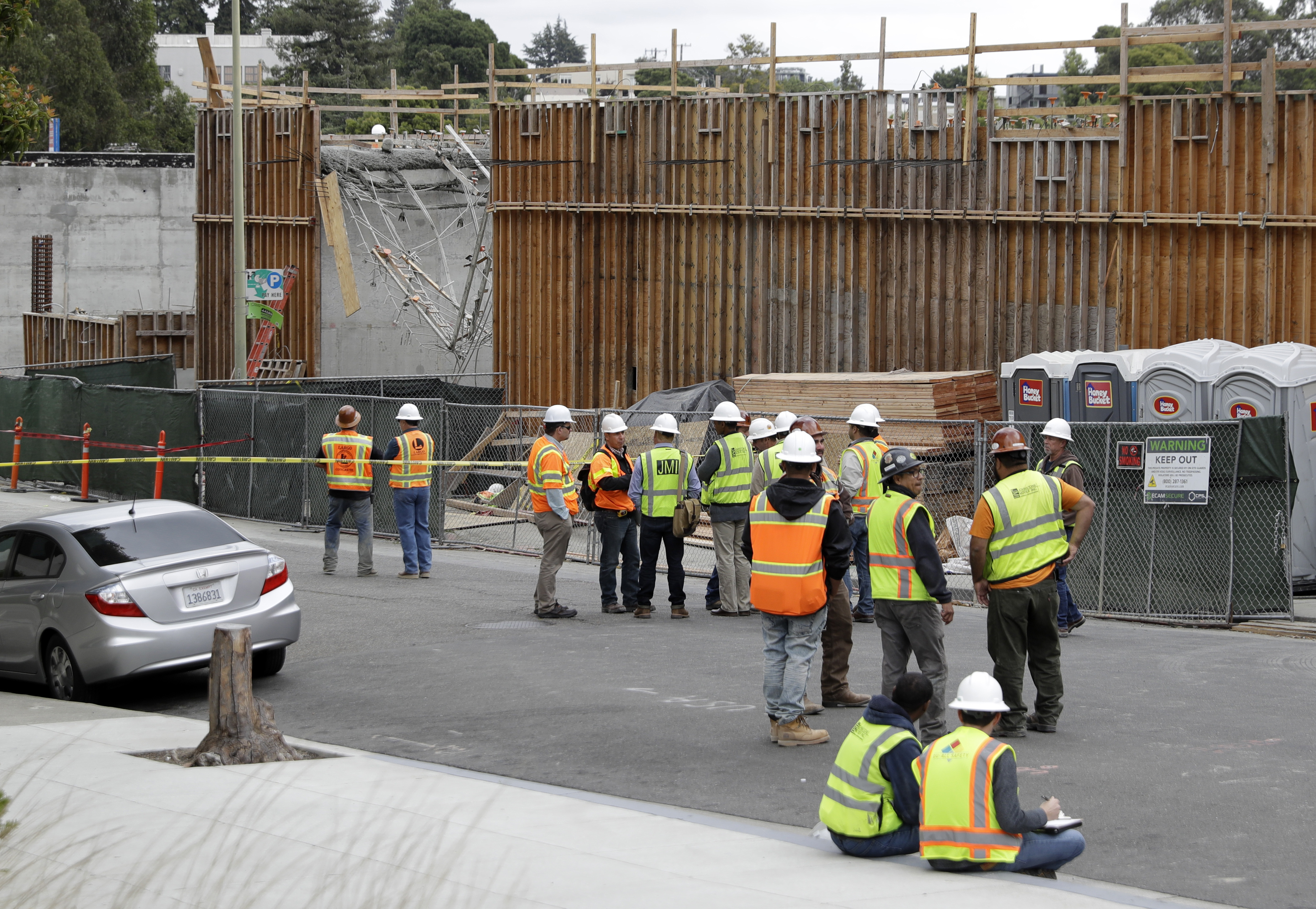 The Latest: Video shows workers dangling at California site