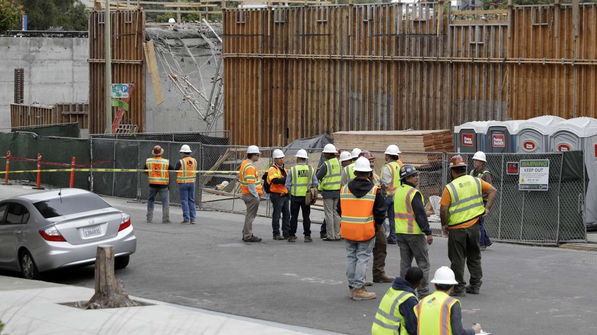 The Latest: Video shows workers dangling at California site