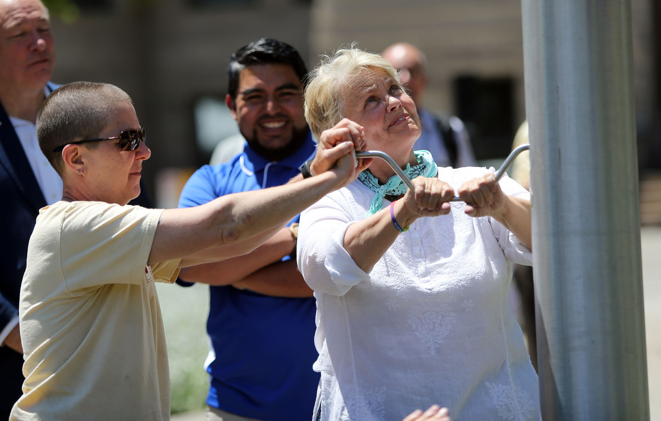 Lu Prickett and Carol Gnade, Utah Pride Center executive director, help raise the original gay pride flag during a press conference to announce the 42nd annual Utah Pride Festival at the Salt Lake City-County Building on Wednesday, May 31, 2017. (Photo: Kristin Murphy, Deseret News)