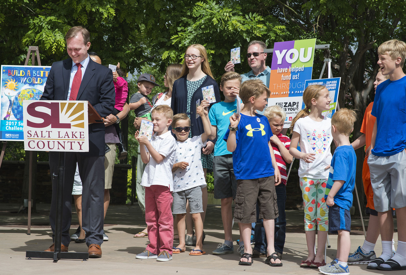 Salt Lake County Mayor Ben McAdams asks to see the kids' new summer passports during his speech at the official kickoff for Salt Lake County's Kids Summer Passport tour at the Conservations Garden Park in West Jordan on Thursday, June 1, 2017. (Photo: Kelsey Brunner, Deseret News)