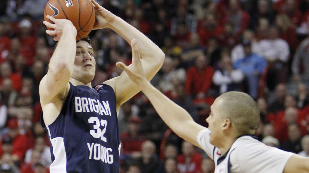 BYU's Jimmer Fredette shoots over UNLV's Derrick Jasper during the first half of an NCAA college basketball game against UNLV Wednesday, Jan. 5, 2011, in Las Vegas.
