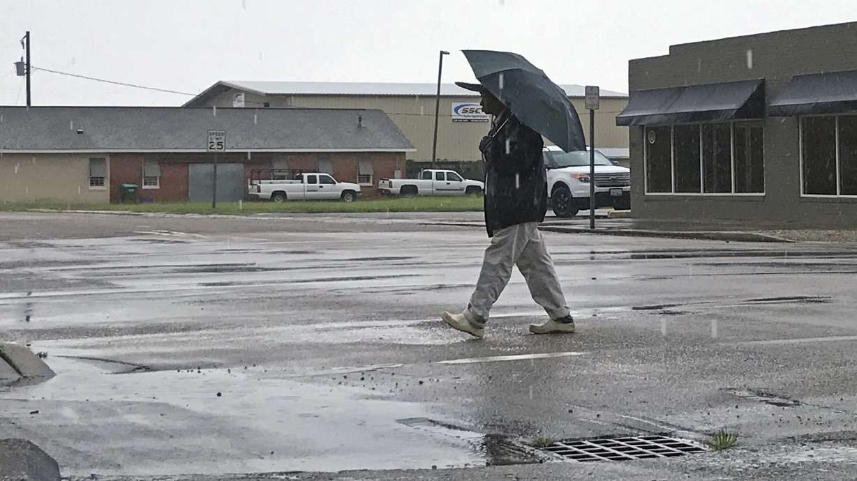 The Latest: Tropical storm warning extended eastward