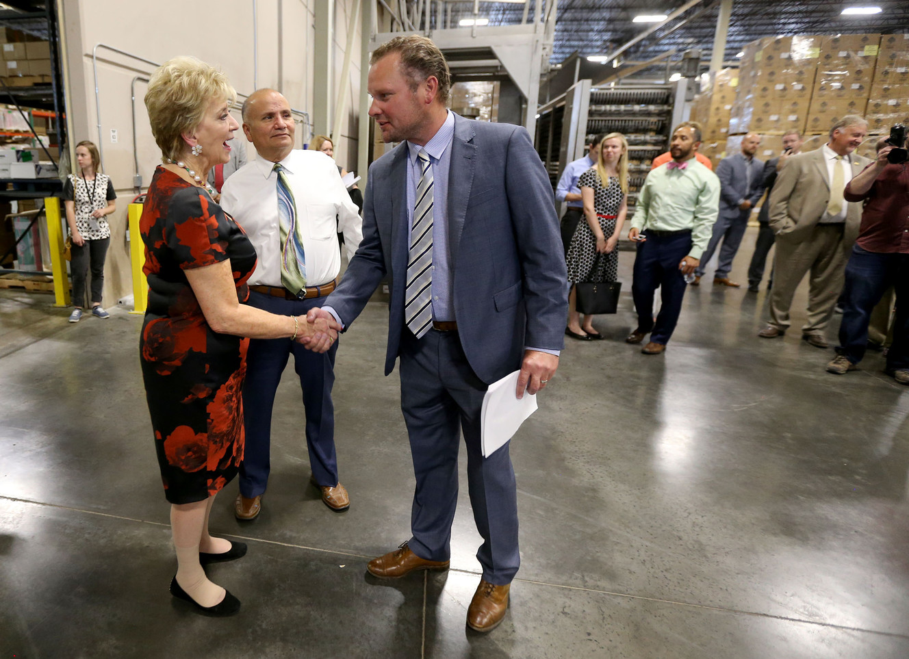 Small Business Administration chief Linda McMahon shakes hands with Adam Stump during a tour of Manuel’s Fine Foods in Woods Cross on Wednesday, June 21, 2017. (Photo: Kristin Murphy, Deseret News)