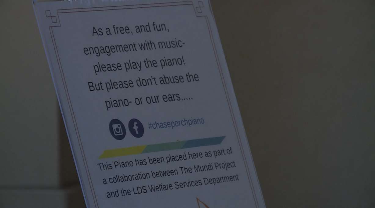 A sign displayed on a piano placed at Liberty Park by Deseret Industries encourages passers-by to play it. In Liberty Park, Wednesday, June 21, 2017. (Photo: Steve Breinholt, KSL TV)