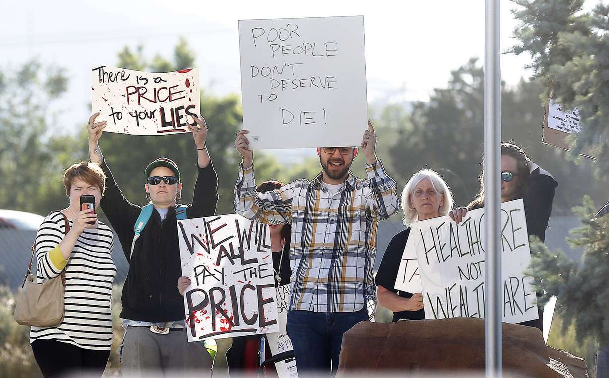 Some protestors gather as Health and Human Services Secretary Tom Price meets with business leaders at Colonial Flag in Sandy on Monday, June 26, 2017. (Photo: Ravell Call, Deseret News)