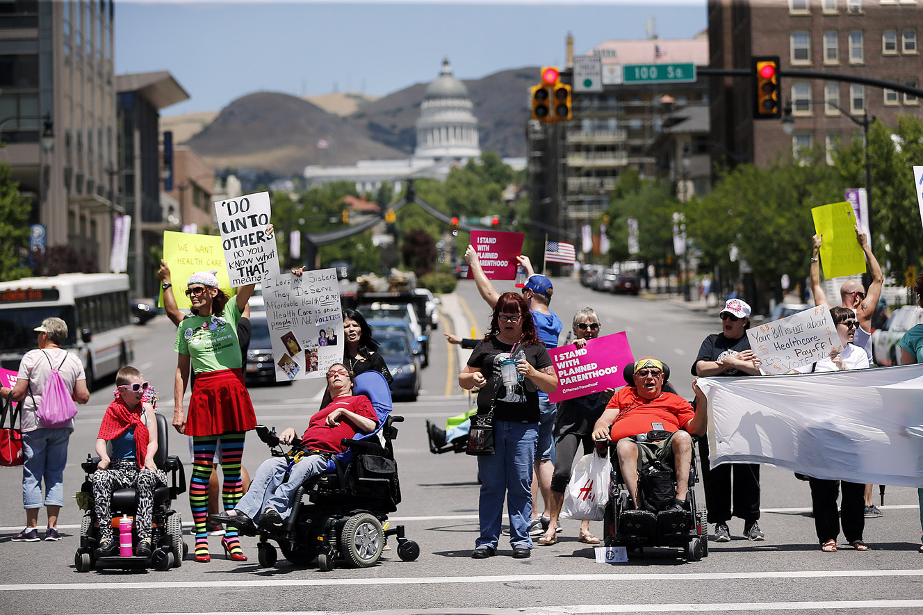 Protesters opposed to a Senate GOP health care bill stand in the middle of State Street during a protest in Salt Lake City on Tuesday, June 27, 2017. (Photo: Ravell Call, Deseret News)