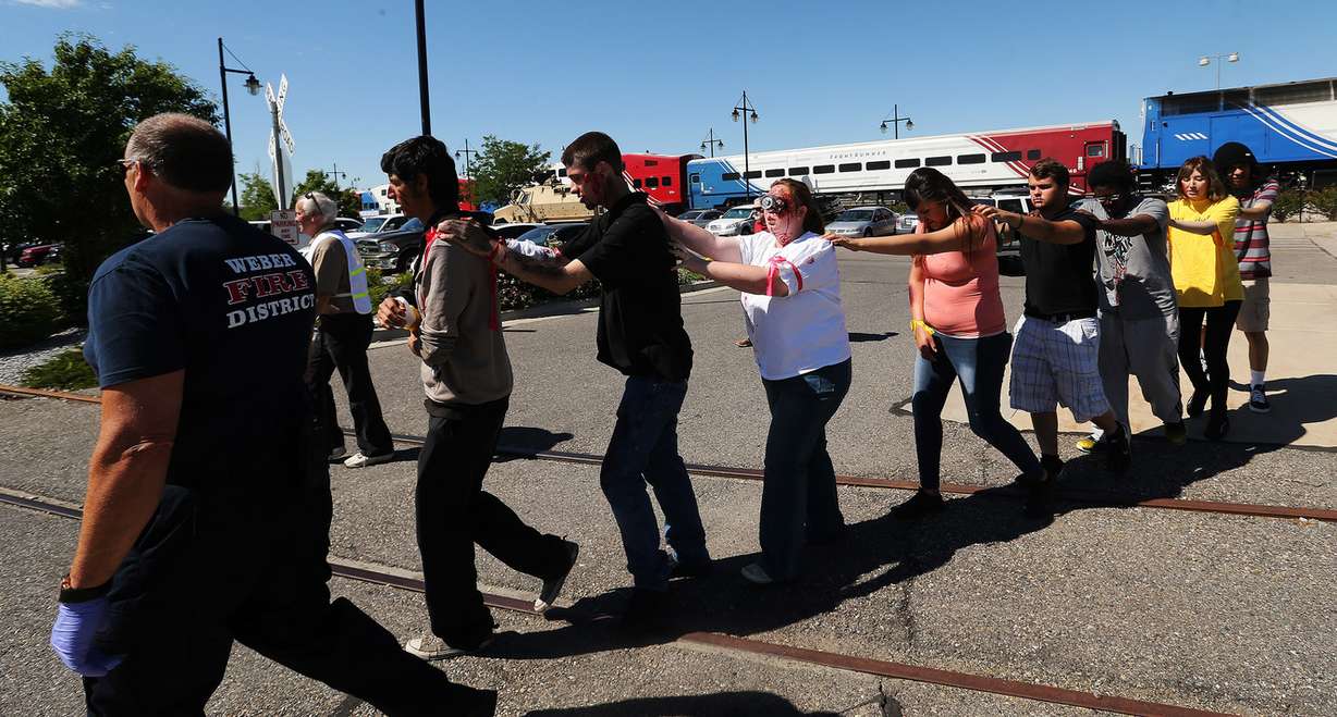 Injured “victims” are led from a train during a full-scale emergency response drill simulating a terrorist suicide bombing on FrontRunner in Ogden on Wednesday, June 28, 2017. Emergency personnel from a wide variety of agencies — including the Utah Transit Authority, FBI, Utah Medical Examiner's Office, and Davis and Weber counties — participated in the exercise. (Photo: Jeffrey D. Allred, Deseret News)