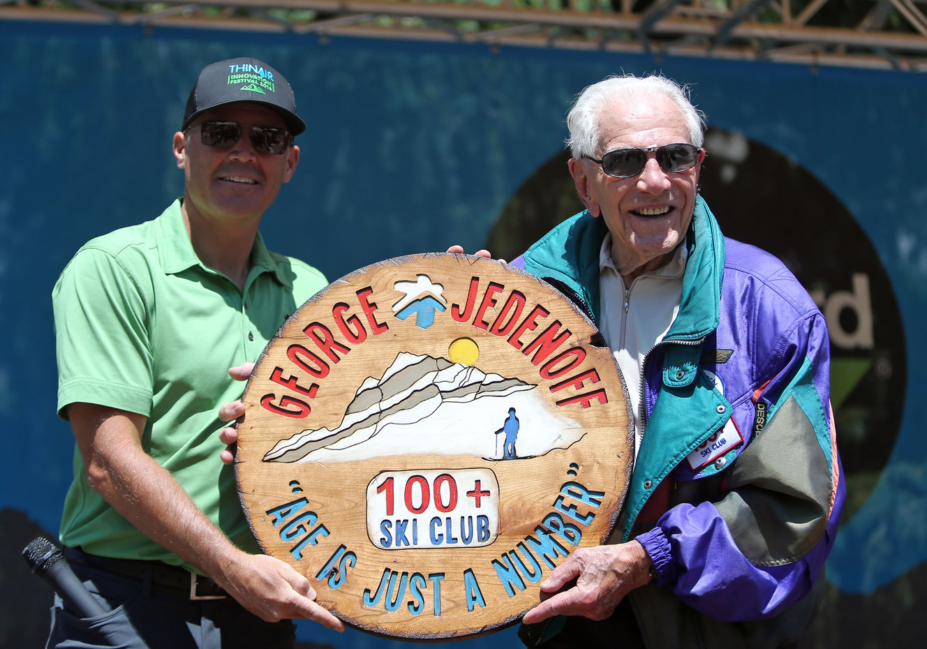 Nathan Rafferty, president and CEO of Ski Utah, presents a gift to George Jedenoff, after Jedenoff skied on his 100th birthday at Snowbird in Little Cottonwood Canyon on Wednesday, July 5, 2017. (Photo: Kristin Murphy, Deseret News)